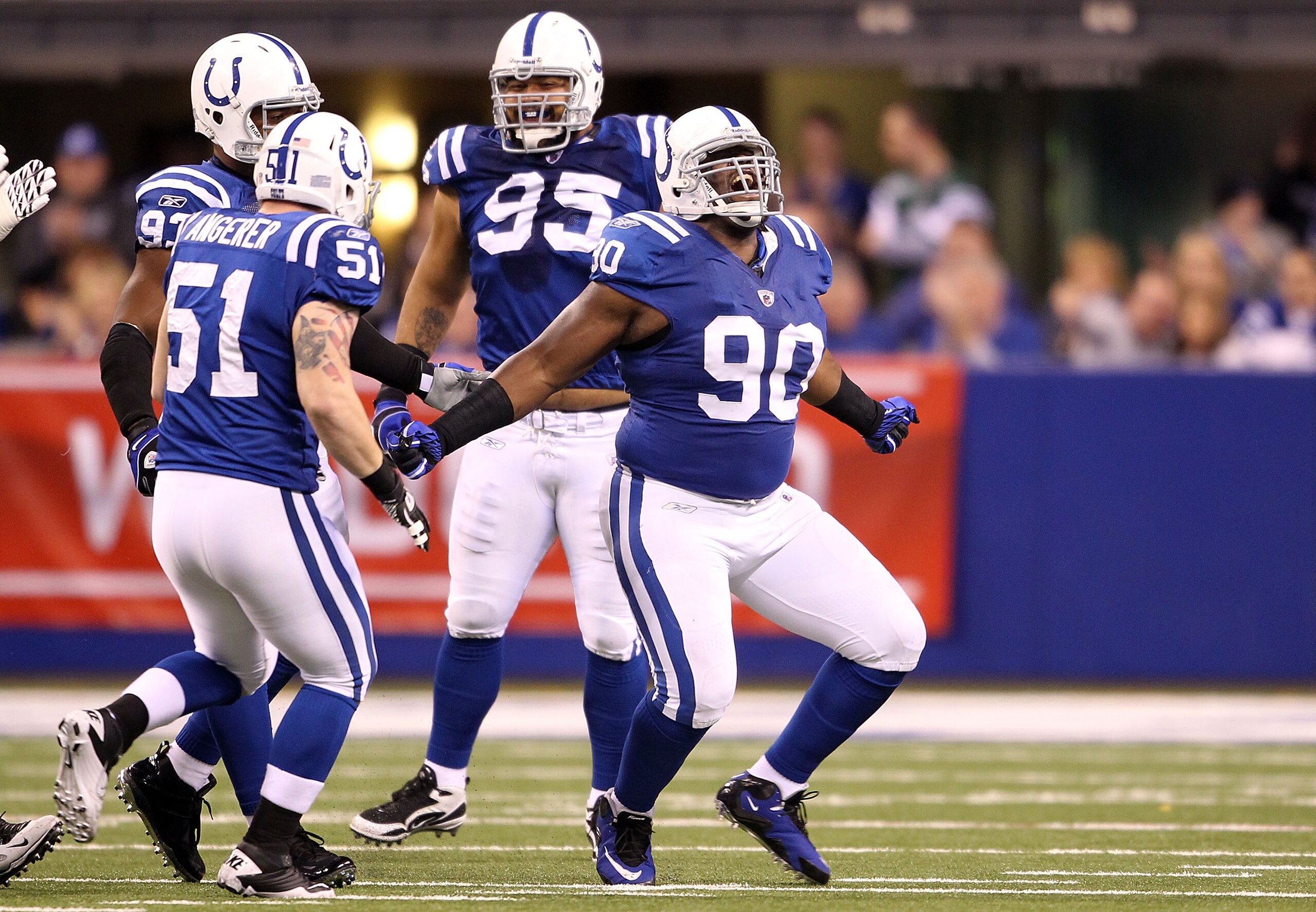 INDIANAPOLIS, IN - JANUARY 08: Dan Muir #90 of the Indianapolis Colts celebrates with Pat Angerer #51 and Fili Moala #95 after he sacked quarterback Mark Sanchez #6 of the New York Jets in the first quarter during their 2011 AFC wild card playoff game at INDIANAPOLIS, IN - JANUARY 08: Dan Muir #90 of the Indianapolis Colts celebrates with Pat Angerer #51 and Fili Moala #95 after he sacked quarterback Mark Sanchez #6 of the New York Jets in the first quarter during their 2011 AFC wild card playoff game at
