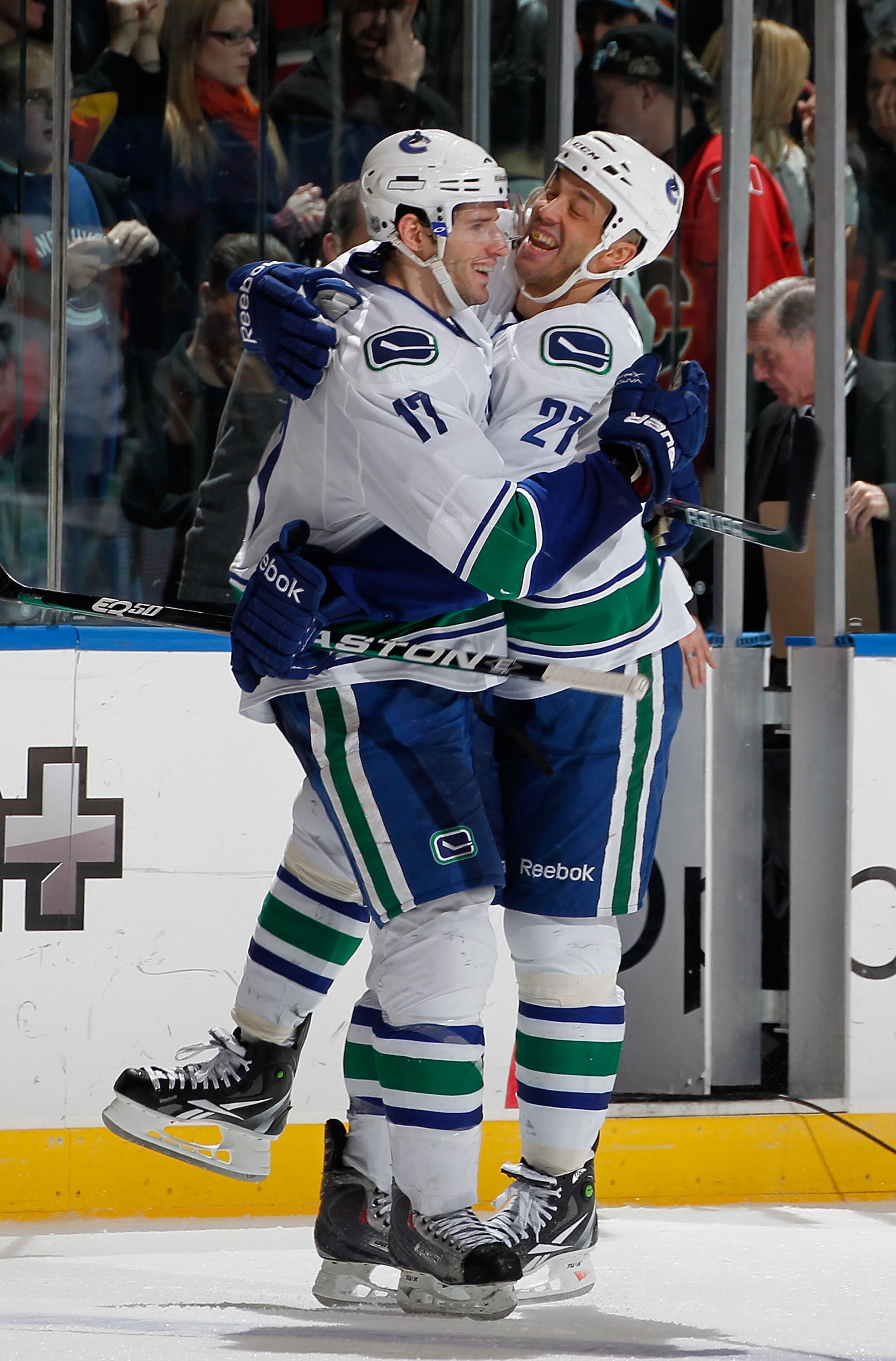 UNIONDALE, NY - JANUARY 11: Ryan Kesler #17 of the Vancouver Canucks is hugged by teammate Manny Malhotra #27 as they celebrate the winning goal by Kesler in the shootout of an NHL hockey game against the New York Islanders at Nassau Coliseum on January UNIONDALE, NY - JANUARY 11: Ryan Kesler #17 of the Vancouver Canucks is hugged by teammate Manny Malhotra #27 as they celebrate the winning goal by Kesler in the shootout of an NHL hockey game against the New York Islanders at Nassau Coliseum on January