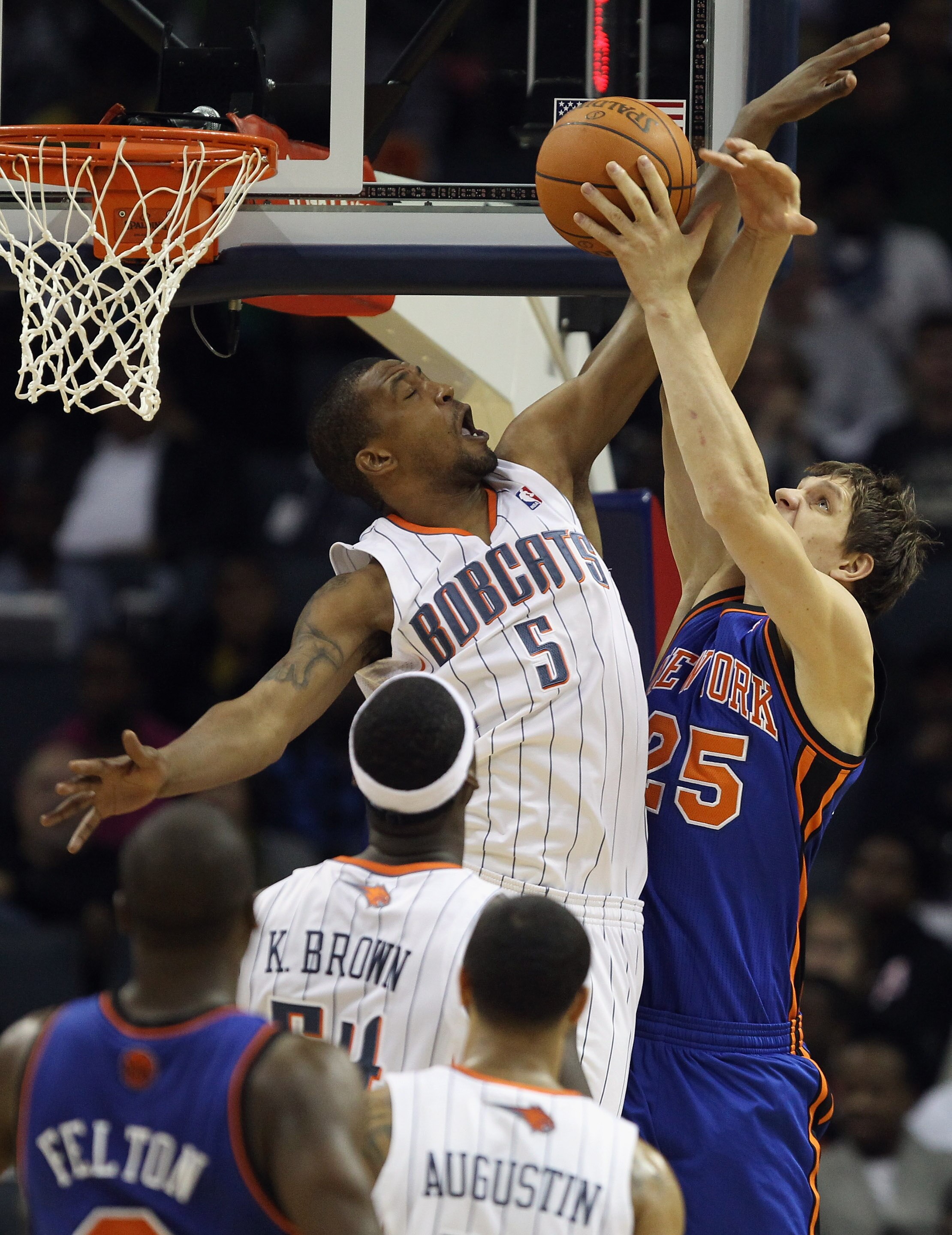 CHARLOTTE, NC - NOVEMBER 24:  Timofey Mozgov #25 of the New York Knicks has his shot blocked by Dominic McGuire #5 of the Charlotte Bobcats during their game at Time Warner Cable Arena on November 24, 2010 in Charlotte, North Carolina.  NOTE TO USER: User