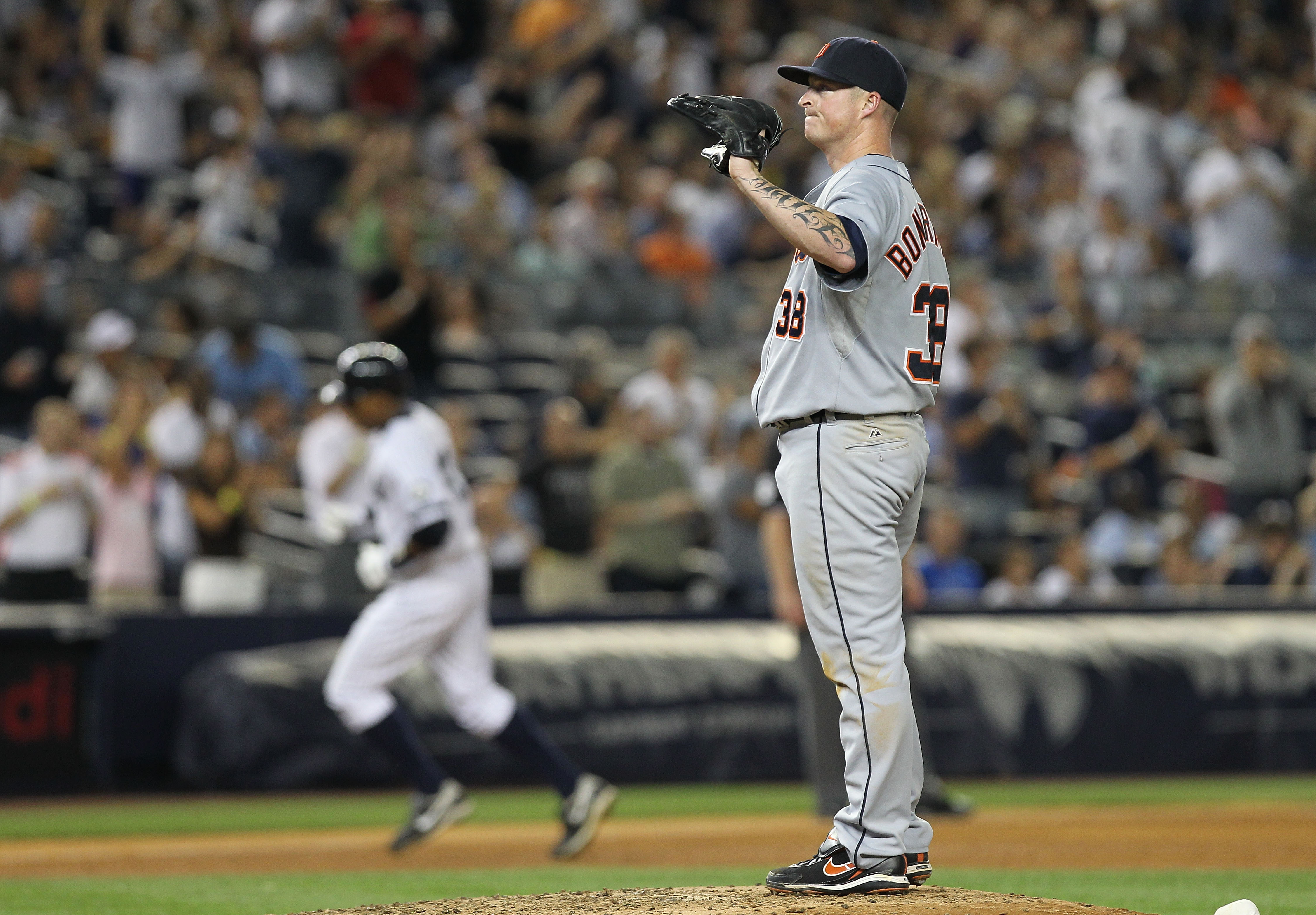 NEW YORK - AUGUST 18:  Jeremy Bonderman #38 of the Detroit Tigers reacts as Curtis Granderson #14 of the New York Yankees rounds the bases at Yankee Stadium on August 18, 2010 in the Bronx borough of New York City.  (Photo by Nick Laham/Getty Images)