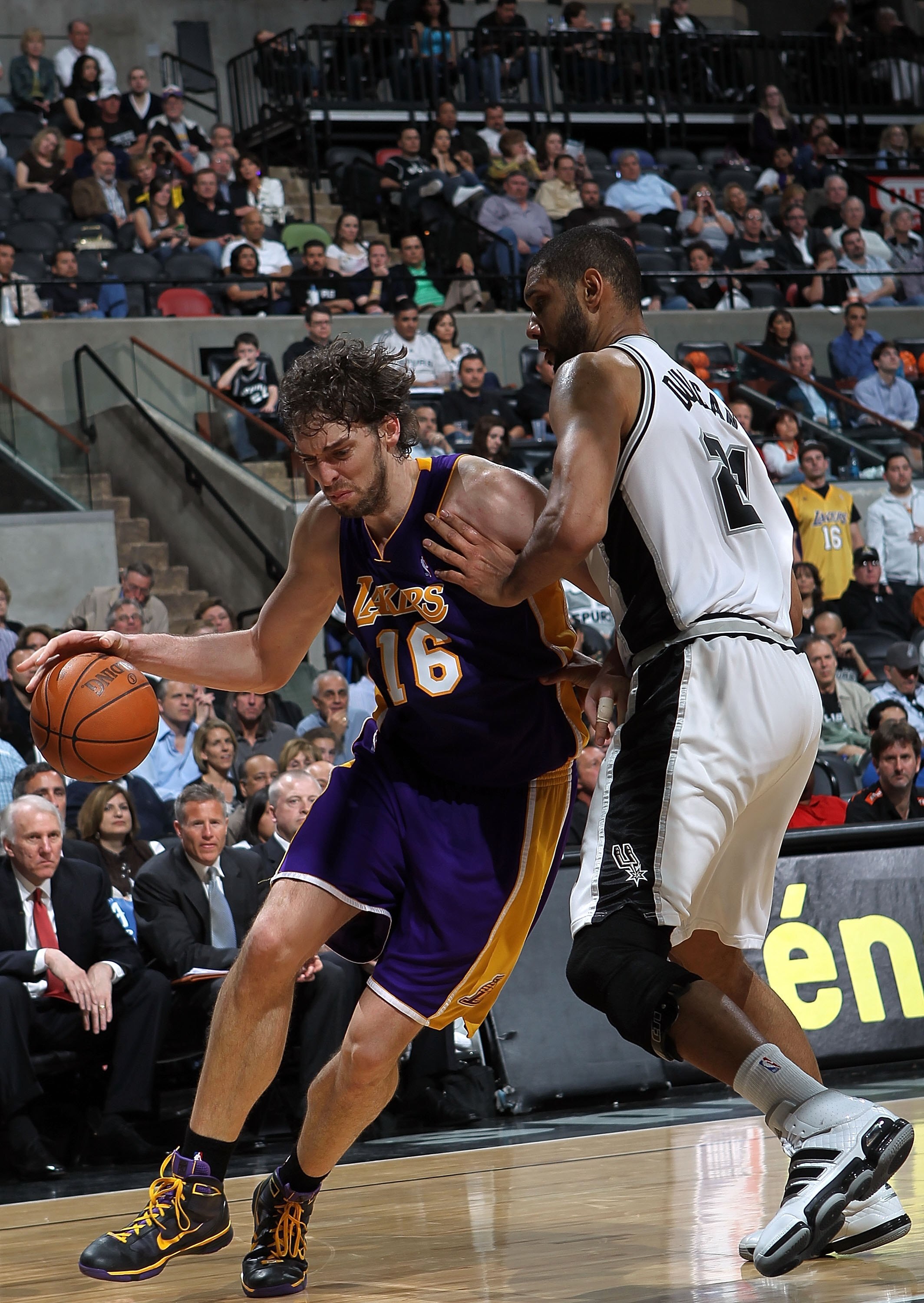 SAN ANTONIO - MARCH 24:  Forward Pau Gasol #16 of the Los Angeles Lakers dribbles the ball past Tim Duncan #21 of the San Antonio Spurs at AT&T Center on March 24, 2010 in San Antonio, Texas.  NOTE TO USER: User expressly acknowledges and agrees that, by