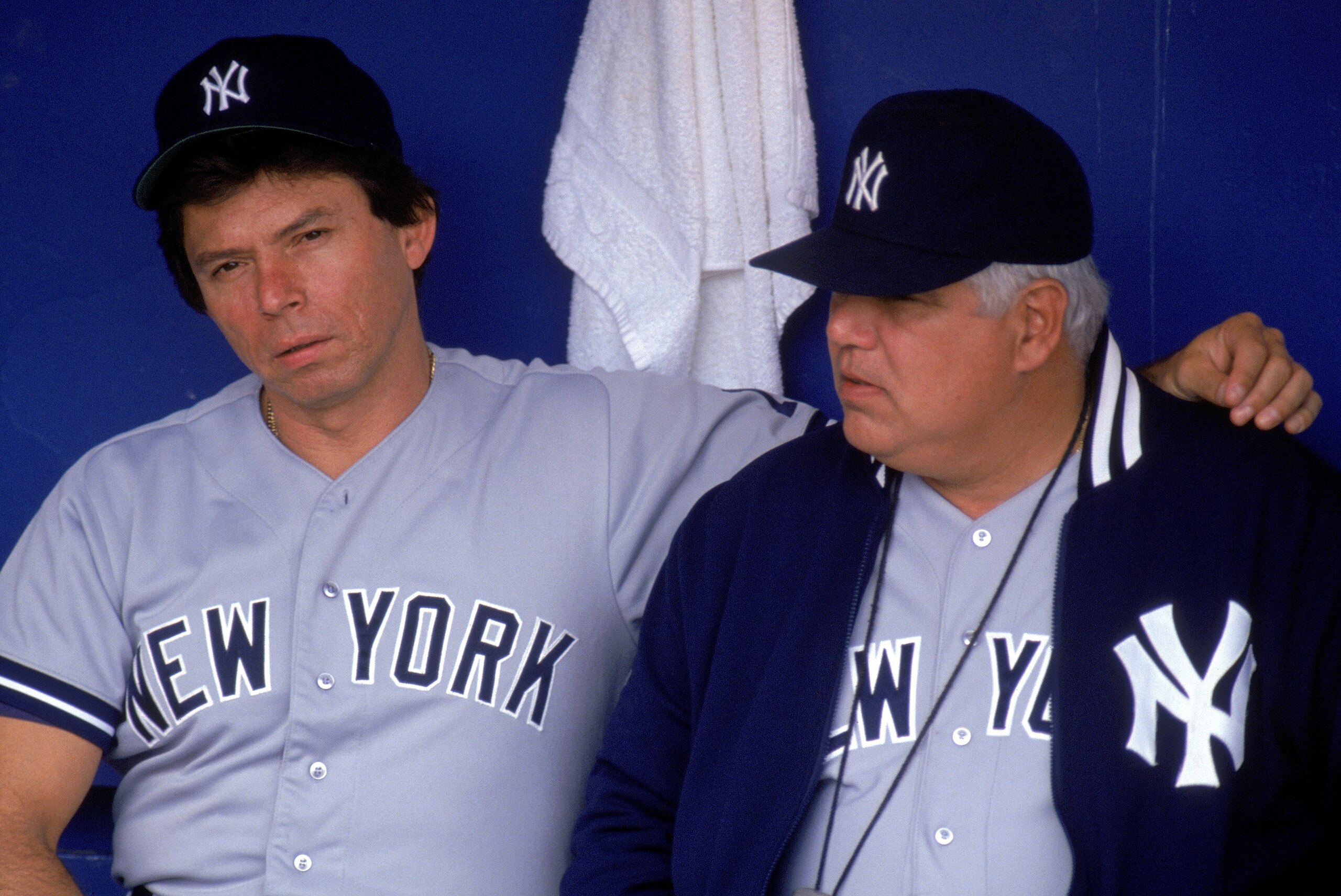 1990:  (L-R) Coach Darrell Evans and pitching coach Billy Connors of the New York Yankees sit in the dugout during a 1990 MLB season game.  (Photo by Jonathan Daniel/Getty Images