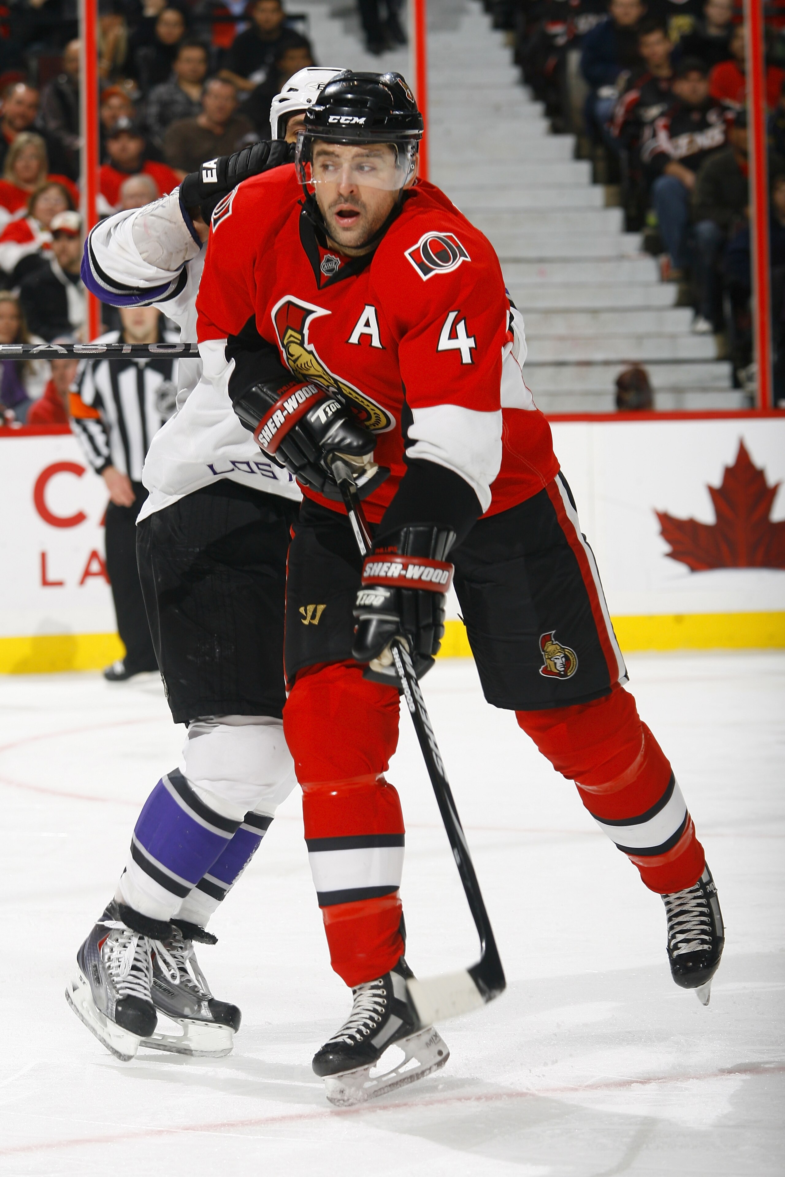 OTTAWA, ON - NOVEMBER 22: Chris Phillips #4 of the Ottawa Senators throws the shoulder into Jarret Stoll #28 of the Los Angeles Kings during a game at Scotiabank Place on November 22, 2010 in Ottawa, Ontario, Canada. (Photo by Phillip MacCallum/Getty Im OTTAWA, ON - NOVEMBER 22: Chris Phillips #4 of the Ottawa Senators throws the shoulder into Jarret Stoll #28 of the Los Angeles Kings during a game at Scotiabank Place on November 22, 2010 in Ottawa, Ontario, Canada. (Photo by Phillip MacCallum/Getty Im