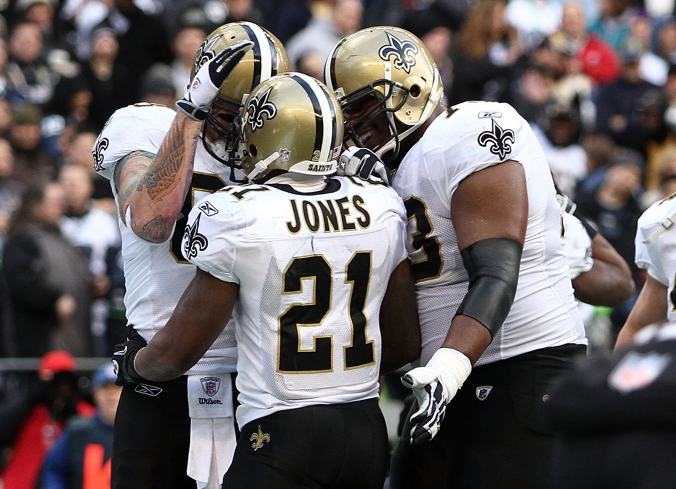 SEATTLE, WA - JANUARY 08:  Julius Jones #21 of the New Orleans Saints celebrates his five-yard touchdown run in the second quarter with teammates against the Seattle Seahawks during the 2011 NFC wild-card playoff game at Qwest Field on January 8, 2011 in