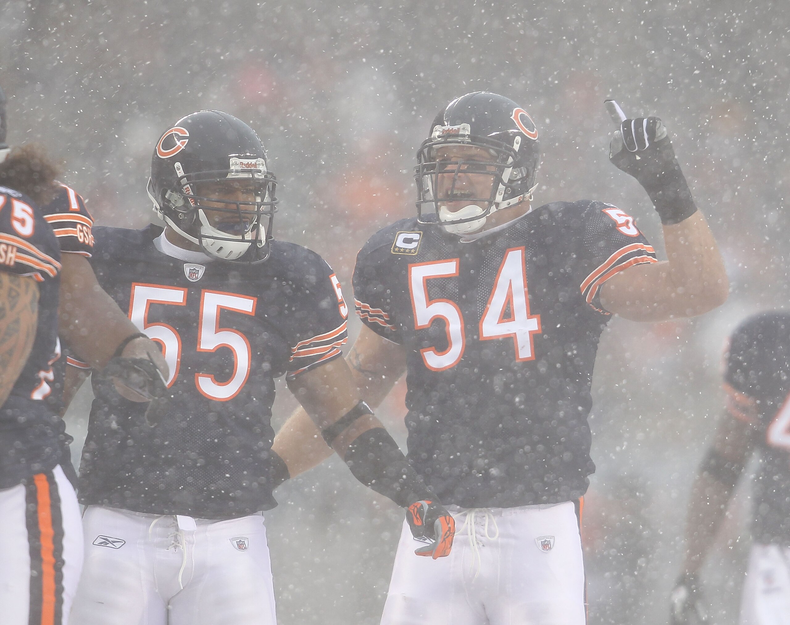 CHICAGO, IL - DECEMBER 12: Brian Urlacher #54 of the Chicago Bears calls a defensive play as teammate Lance Briggs #55 moves into position against the New England Patriots at Soldier Field on December 12, 2010 in Chicago, Illinois. The Patriots defeated t