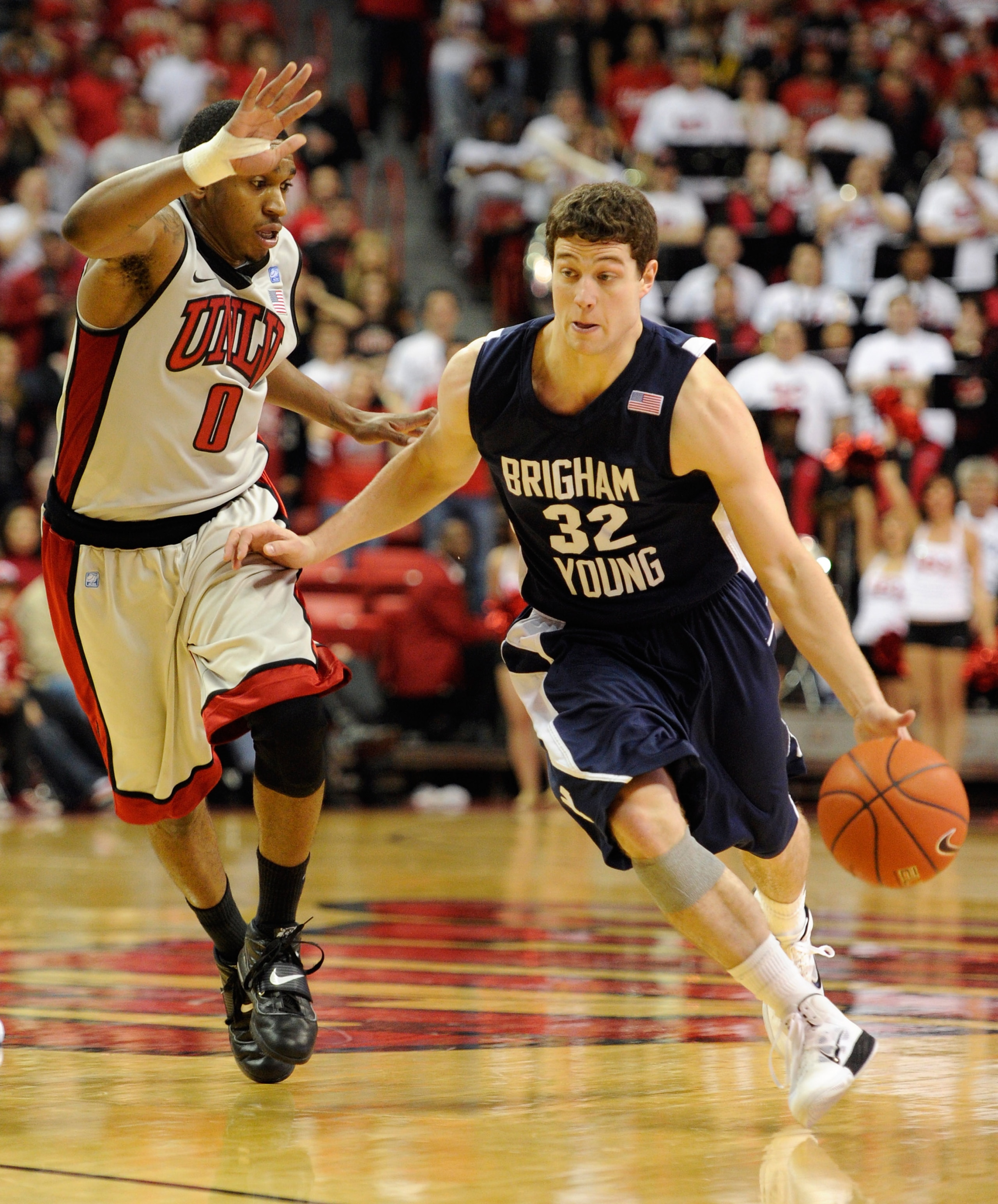 LAS VEGAS, NV - JANUARY 05: Jimmer Fredette #32 of the Brigham Young University Cougars drives against Oscar Bellfield #0 of the UNLV Rebels during their game at the Thomas & Mack Center January 5, 2011 in Las Vegas, Nevada. BYU won 89-77. (Photo by Et LAS VEGAS, NV - JANUARY 05: Jimmer Fredette #32 of the Brigham Young University Cougars drives against Oscar Bellfield #0 of the UNLV Rebels during their game at the Thomas & Mack Center January 5, 2011 in Las Vegas, Nevada. BYU won 89-77. (Photo by Et