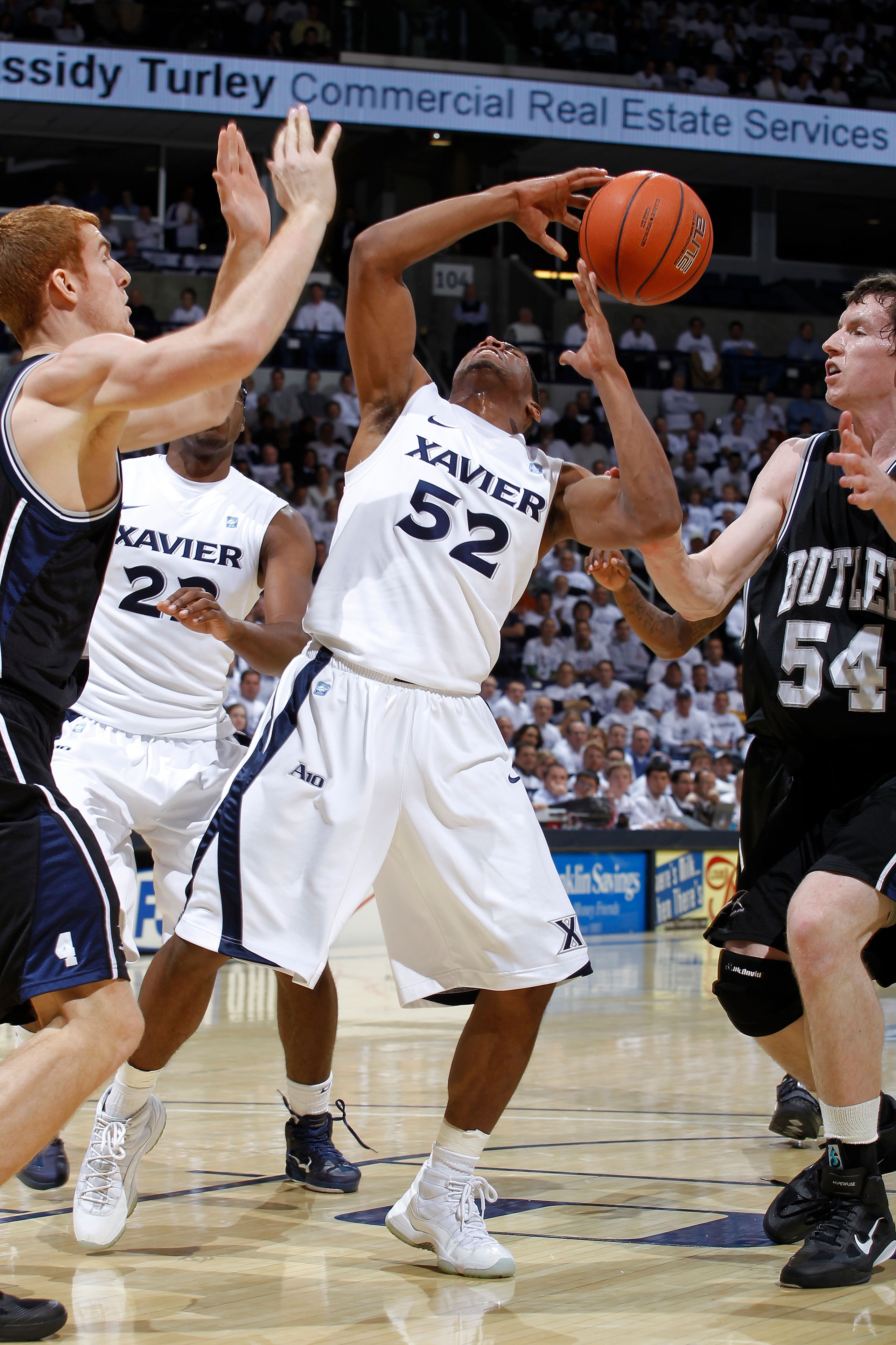 CINCINNATI, OH - DECEMBER 9: Tu Holloway #52 of the Xavier Musketeers has the ball knocked away by Matt Howard #54 of the Butler Bulldogs at Cintas Center on December 9, 2010 in Cincinnati, Ohio. Xavier defeated Butler 51-49. (Photo by Joe Robbins/Getty I CINCINNATI, OH - DECEMBER 9: Tu Holloway #52 of the Xavier Musketeers has the ball knocked away by Matt Howard #54 of the Butler Bulldogs at Cintas Center on December 9, 2010 in Cincinnati, Ohio. Xavier defeated Butler 51-49. (Photo by Joe Robbins/Getty I
