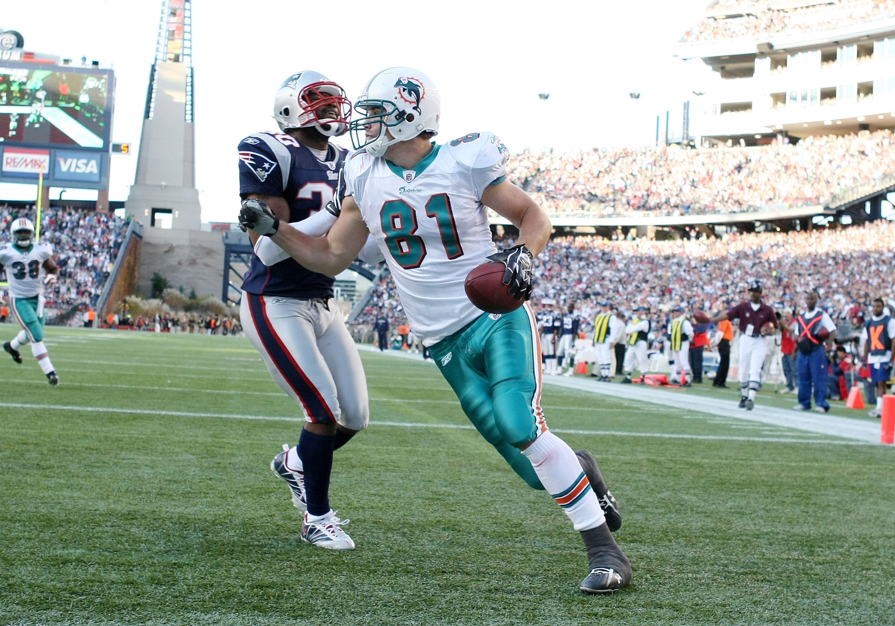 FOXBORO, MA - NOVEMBER 08:  Joey Haynos #81 of the Miami Dolphins celebrates his touchdown as Brandon McGowan #30 of the New England Patriots defends on November 8, 2009 at Gillette Stadium in Foxboro, Massachusetts. The Patriots defeated the Dolphins 27-