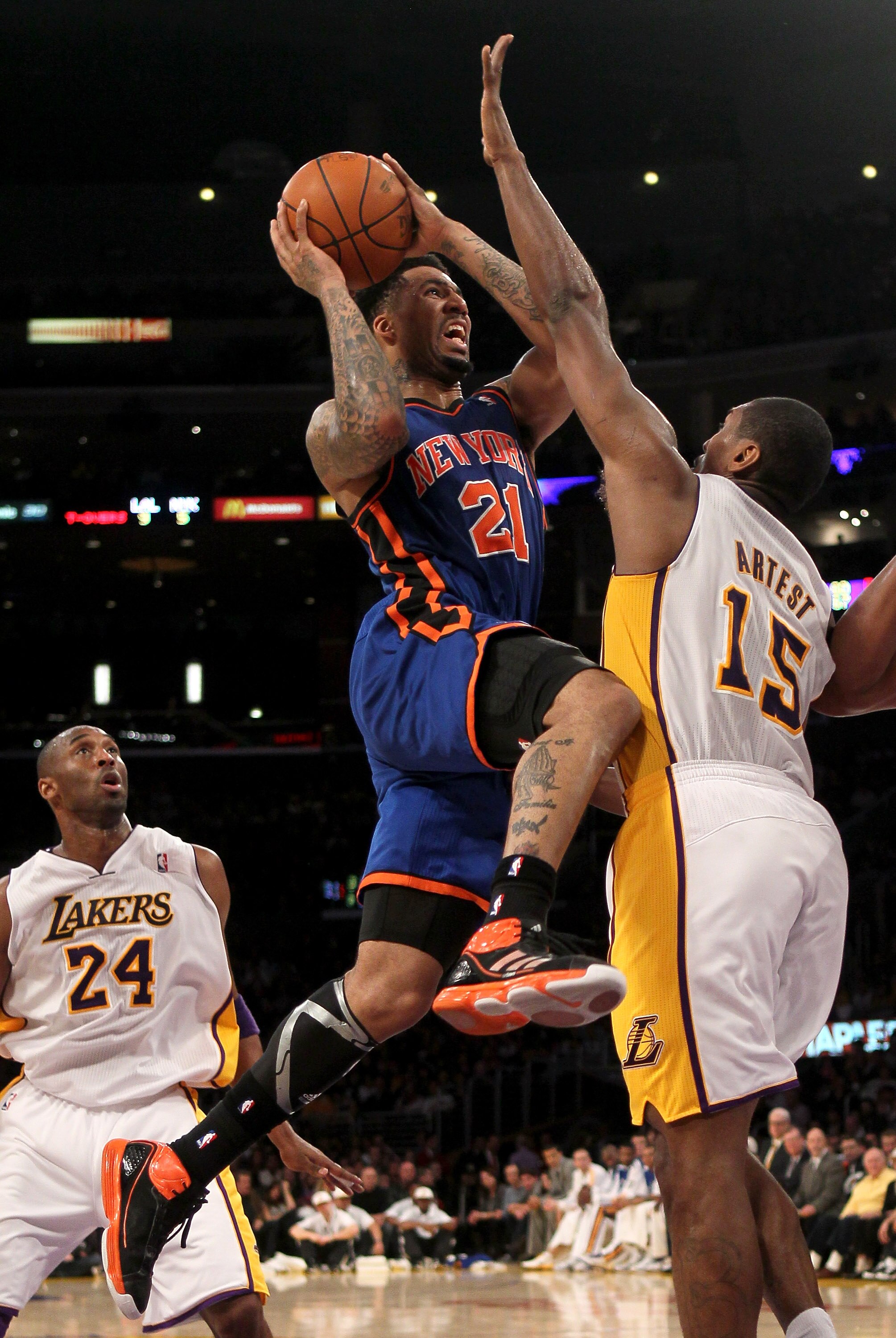 LOS ANGELES, CA - JANUARY 09:  Wilson Chandler #21 of the New York Knicks goes up for a shot over Andrew Bynum #17 of the Los Angeles Lakers at Staples Center on January 9, 2011 in Los Angeles, California.  The Lakers won 109-87.   NOTE TO USER: User expr