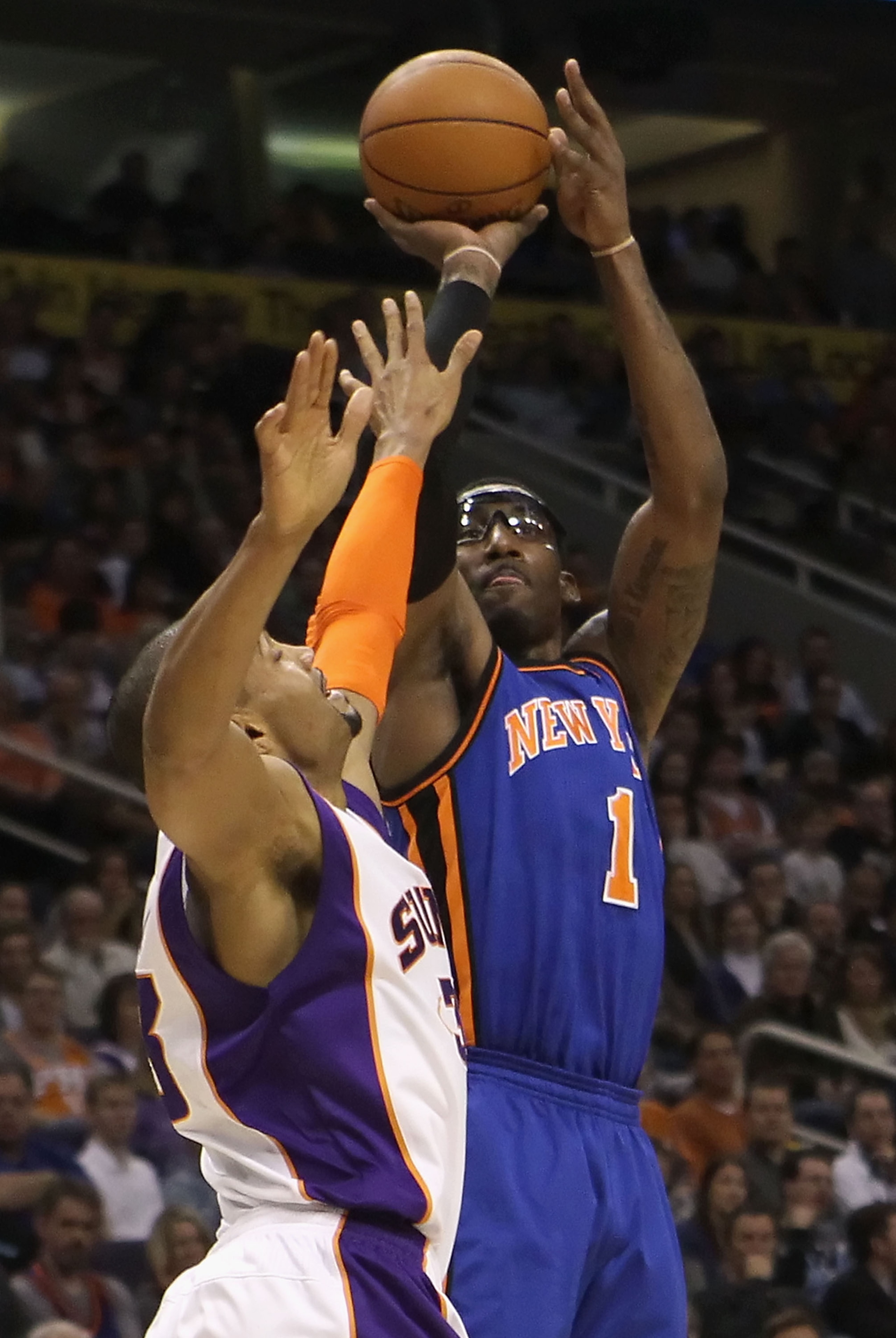 PHOENIX - JANUARY 07:  Amar'e Stoudemire #1 of the New York Knicks puts up a shot over Grant Hill #33 of the Phoenix Suns during the NBA game at US Airways Center on January 7, 2011 in Phoenix, Arizona.  NOTE TO USER: User expressly acknowledges and agree