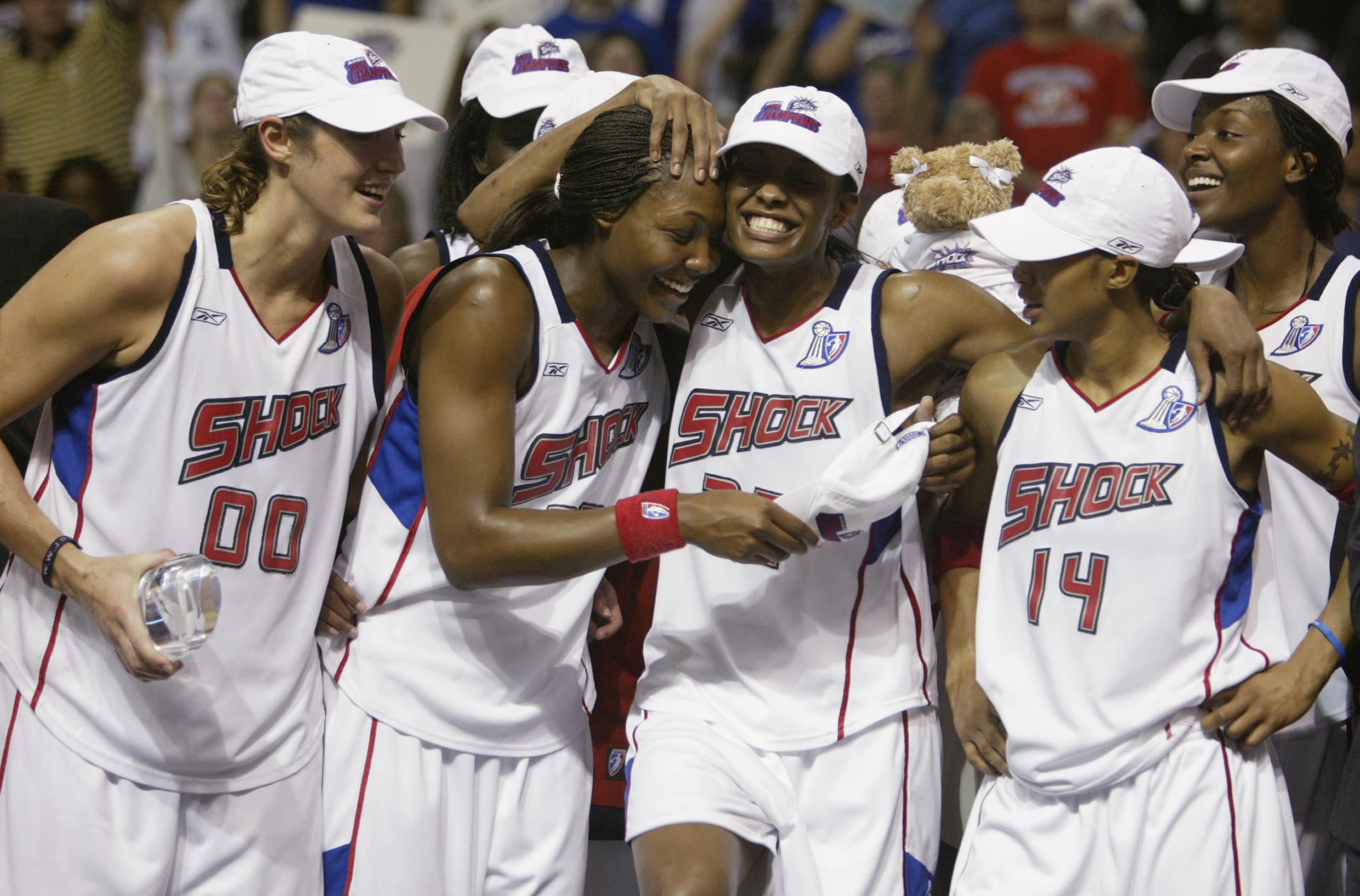 AUBURN HILLS, MI - SEPTEMBER 16:  (L to R) Ruth Riley #00, Cheryl Ford #35, Swin Cash #32, Deanna Nolan #14 and Barbara Ferris #54 of the Detroit Shock celebrate on the podium after defeating the two-time champion Los Angeles Sparks in Game three of the 2