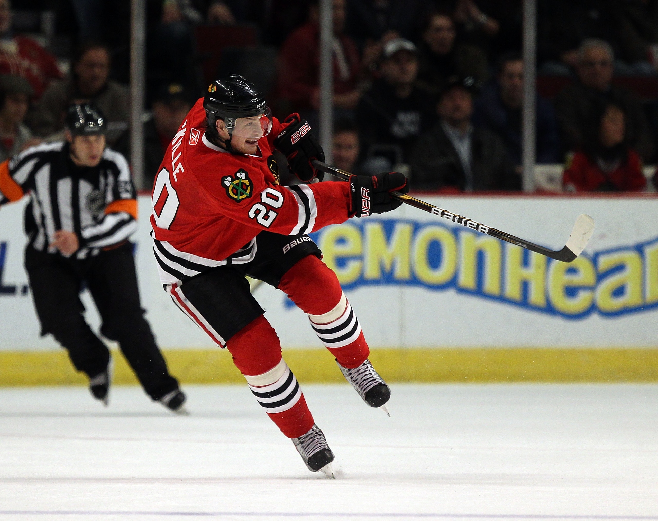 CHICAGO, IL - DECEMBER 17: Jack Skille #20 of the Chicago Blackhawks passes the puck against the Detroit Red Wings at the United Center on December 17, 2010 in Chicago, Illinois. The Blackhawks defeated the Red Wings 4-1. (Photo by Jonathan Daniel/Getty I