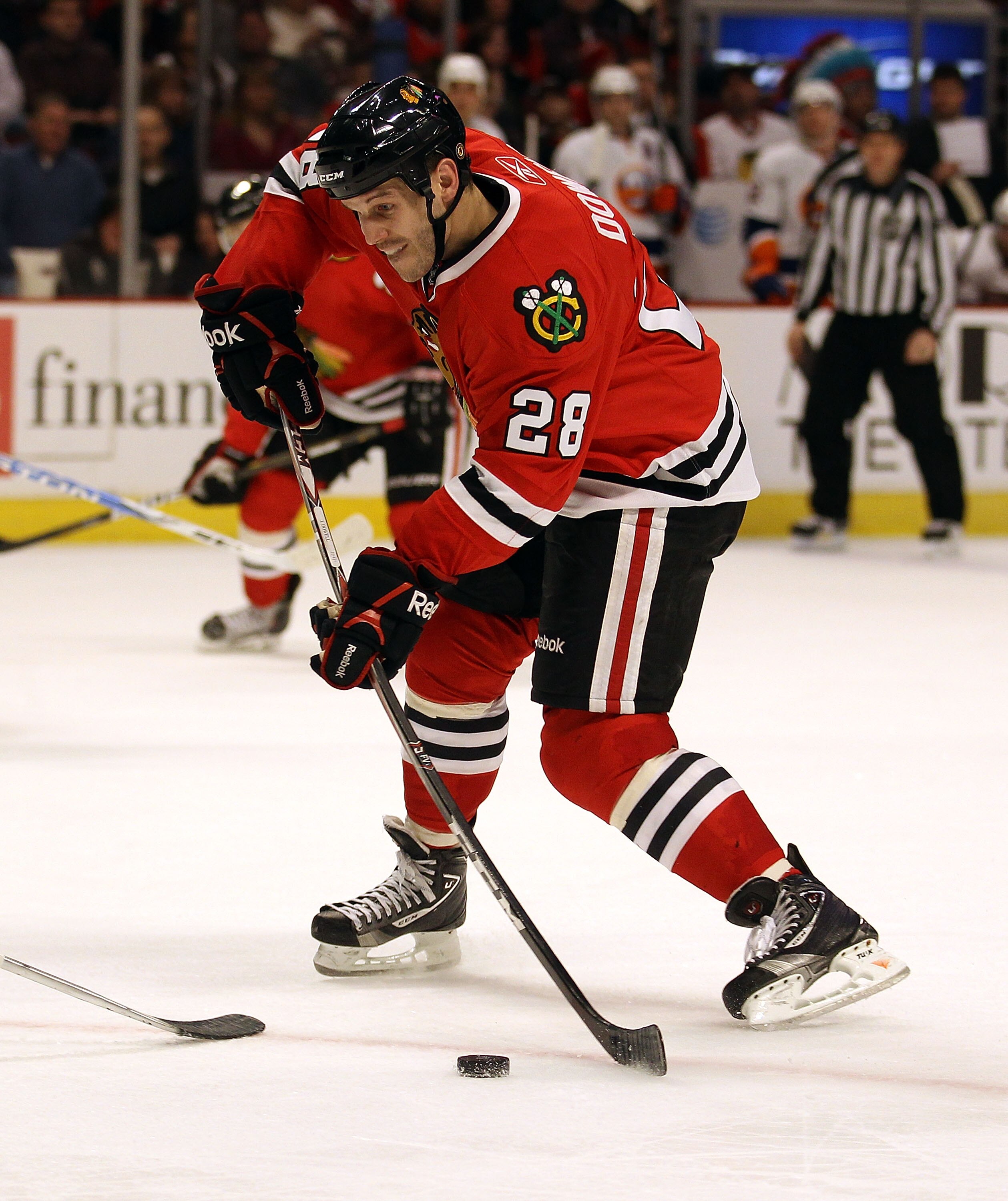 CHICAGO, IL - JANUARY 09: Jake Dowell #28 of the Chicago Blackhawks shoots the puck against the New York Islanders at the United Center on January 9, 2011 in Chicago, Illinois. The Blackhawks defeated the Islanders 5-0. (Photo by Jonathan Daniel/Getty Ima