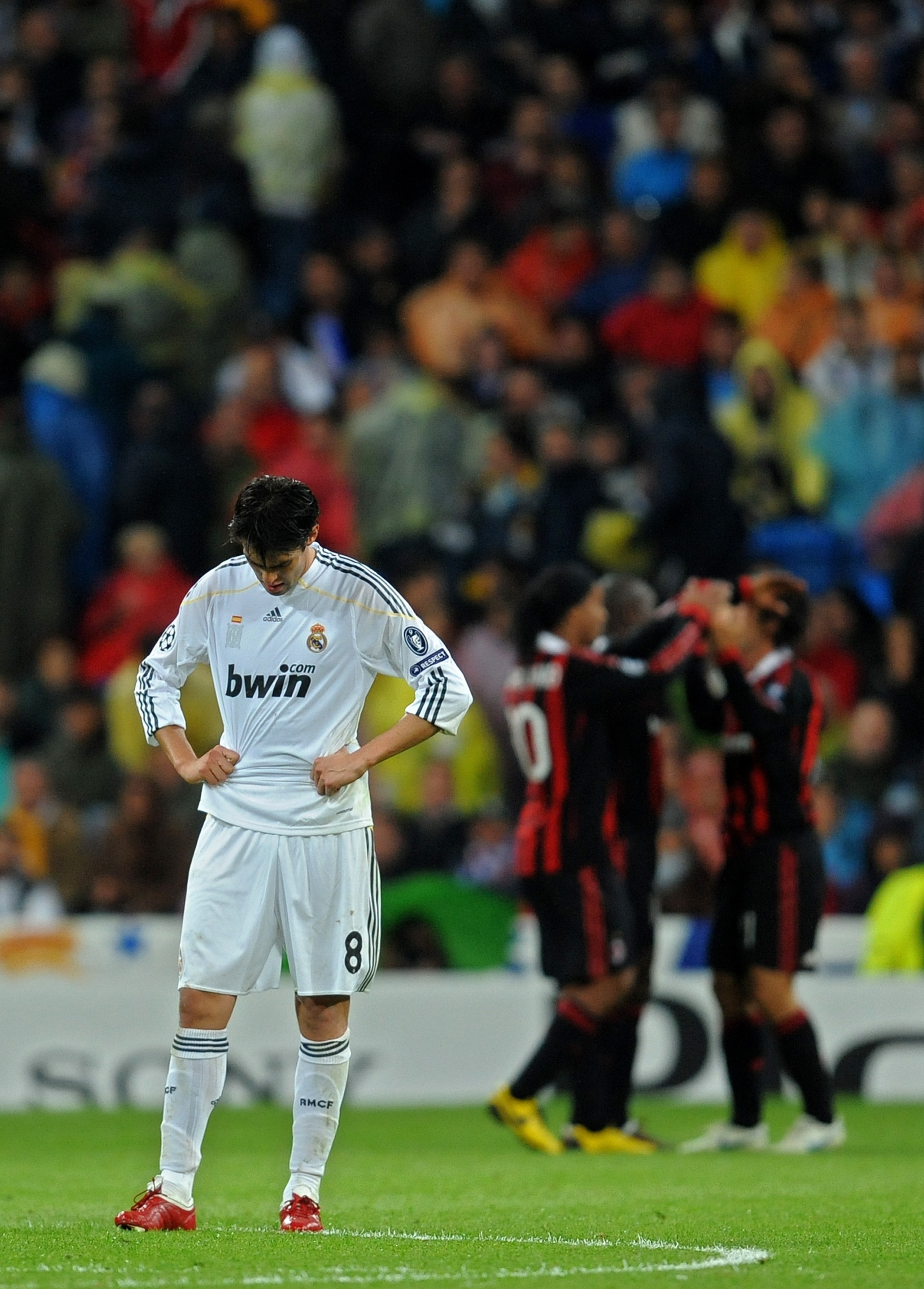 MADRID, SPAIN - OCTOBER 21: Kaka (L) of Real Madrid stands dejected after conceding a goal as AC Milan players celebrate in the background during the Champions League group C match between Real Madrid and AC Milan at the Estadio Santiago Bernabeu on Octo MADRID, SPAIN - OCTOBER 21: Kaka (L) of Real Madrid stands dejected after conceding a goal as AC Milan players celebrate in the background during the Champions League group C match between Real Madrid and AC Milan at the Estadio Santiago Bernabeu on Octo