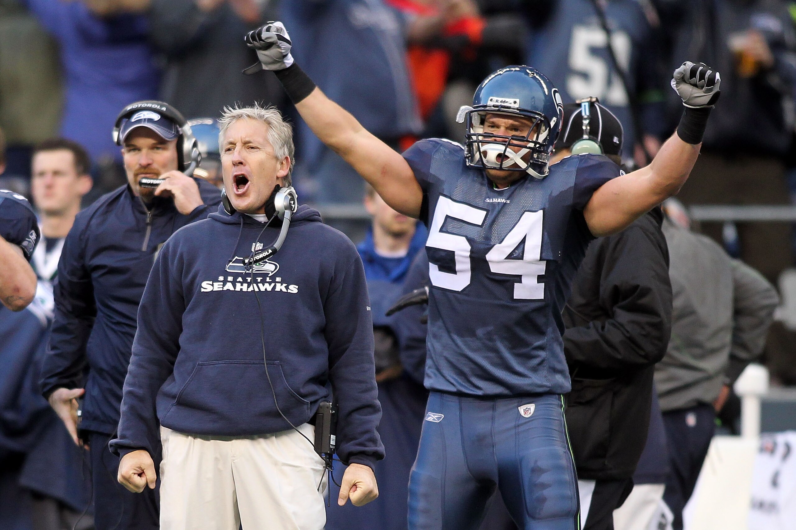 SEATTLE, WA - JANUARY 08:  Head coach Pete Carroll and Will Herring #54 of the Seattle Seahawks celebrate a fourth down stop by the Seahawks in the third quarter against the New Orleans Saints during the 2011 NFC wild-card playoff game at Qwest Field on J