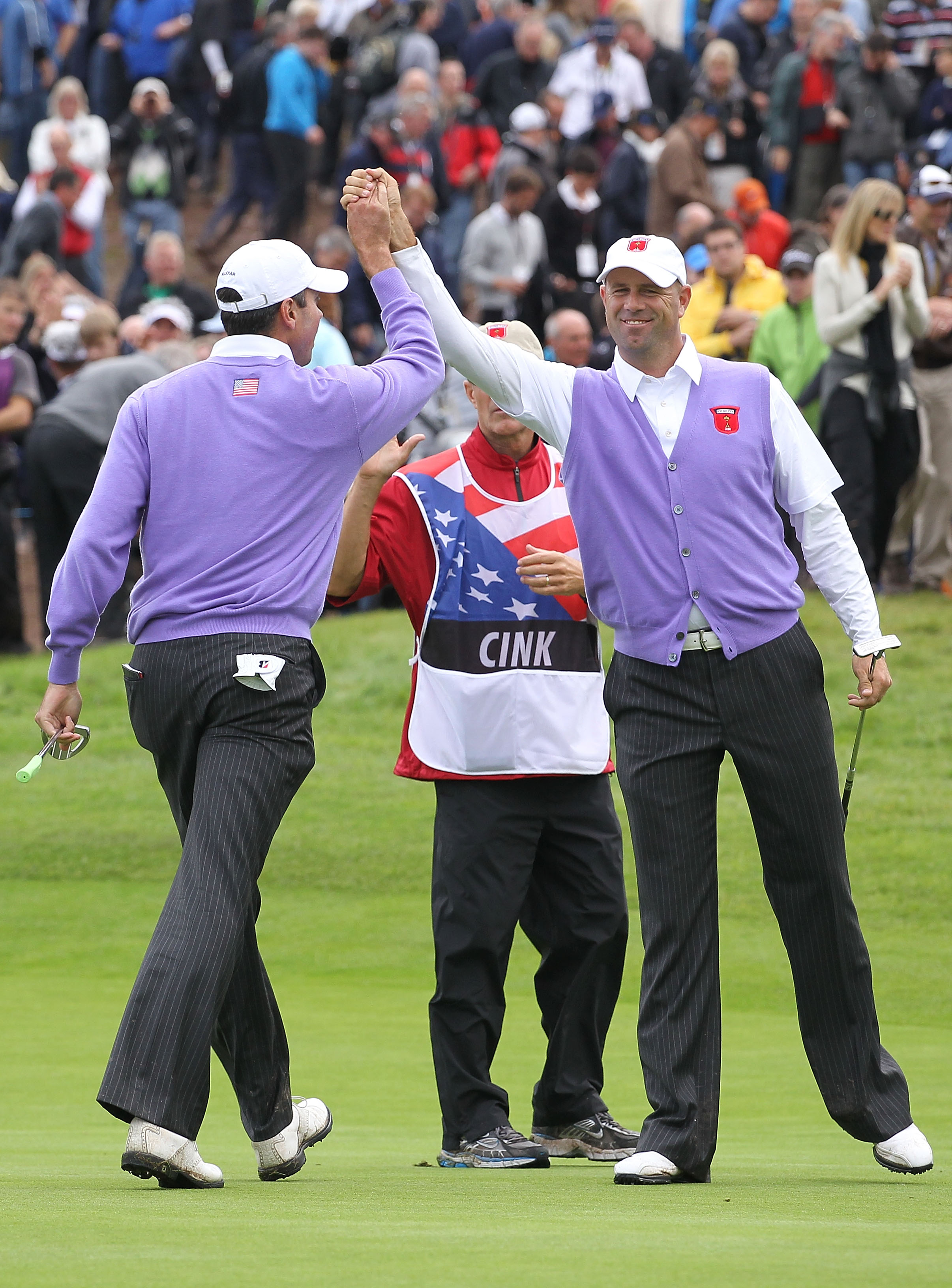 NEWPORT, WALES - OCTOBER 02:  Stewart Cink (R) of the USA celebrates his birdie putt on the 17th green with playing partner Matt Kuchar during the rescheduled Afternoon Foursome Matches during the 2010 Ryder Cup at the Celtic Manor Resort on October 2, 20