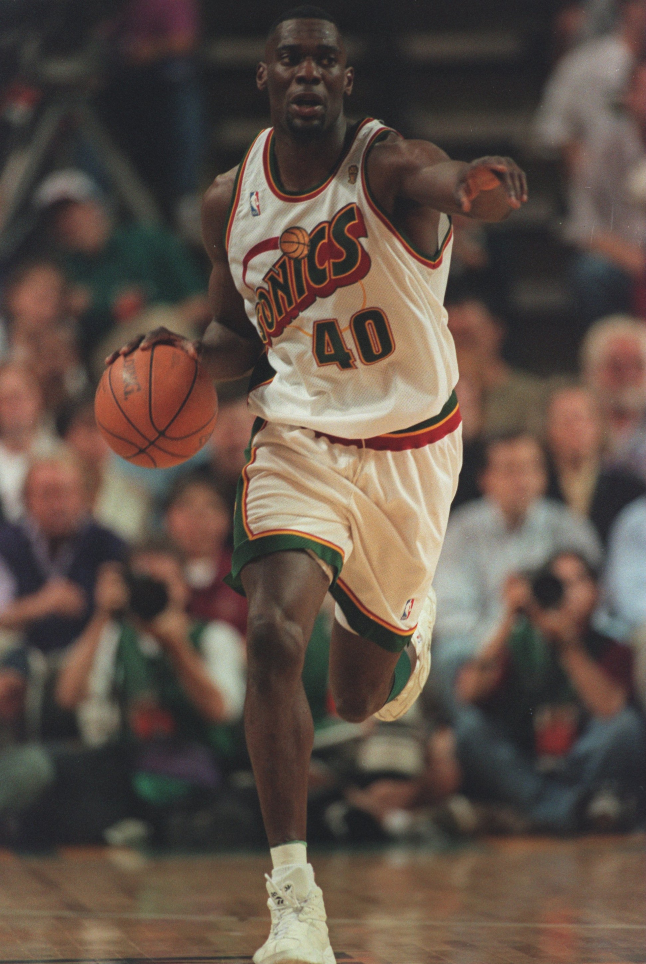 14 Jun 1996:  Forward Shawn Kemp of the Seattle Supersonics looks up court as he signals to his teammate while dribbling the basketball on a fast break during the Sonics 89-78 victory over the Chicago Bulls in the NBA Championship Finals at the Key Arena