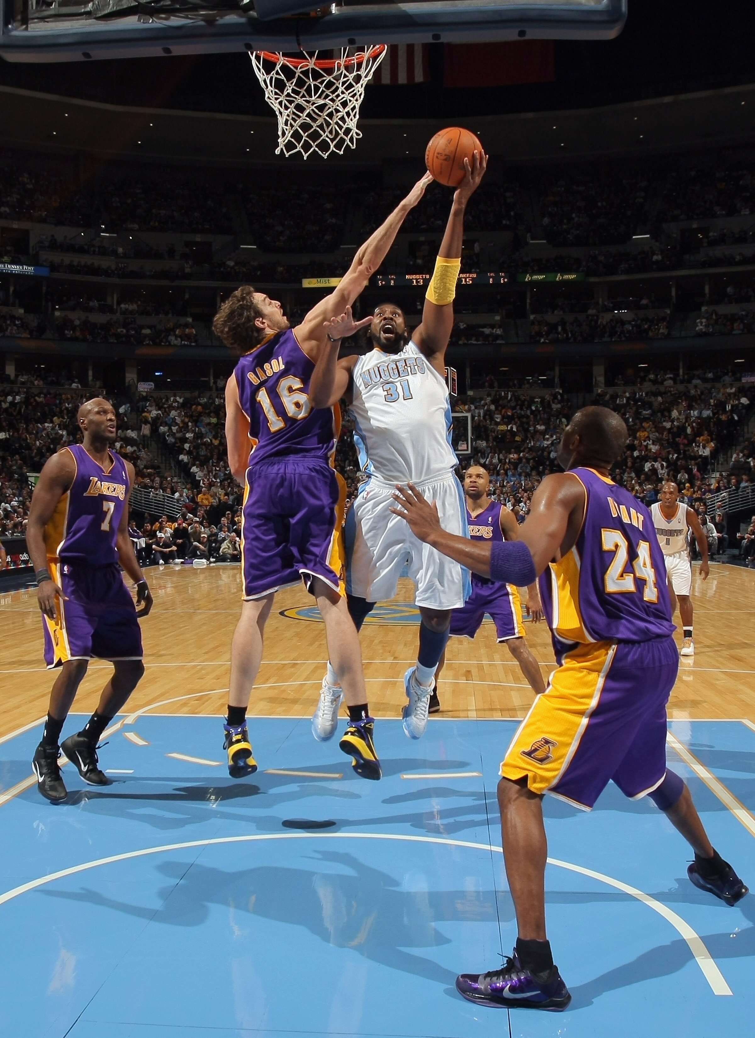DENVER - NOVEMBER 11:  Nene #16 of the Denver Nuggets takes a shot against Pau Gasol #16 of the Los Angeles Lakers at the Pepsi Center on November 11, 2010 in Denver, Colorado. The Nuggets defeated the Lakers 118-112.  NOTE TO USER: User expressly acknowl