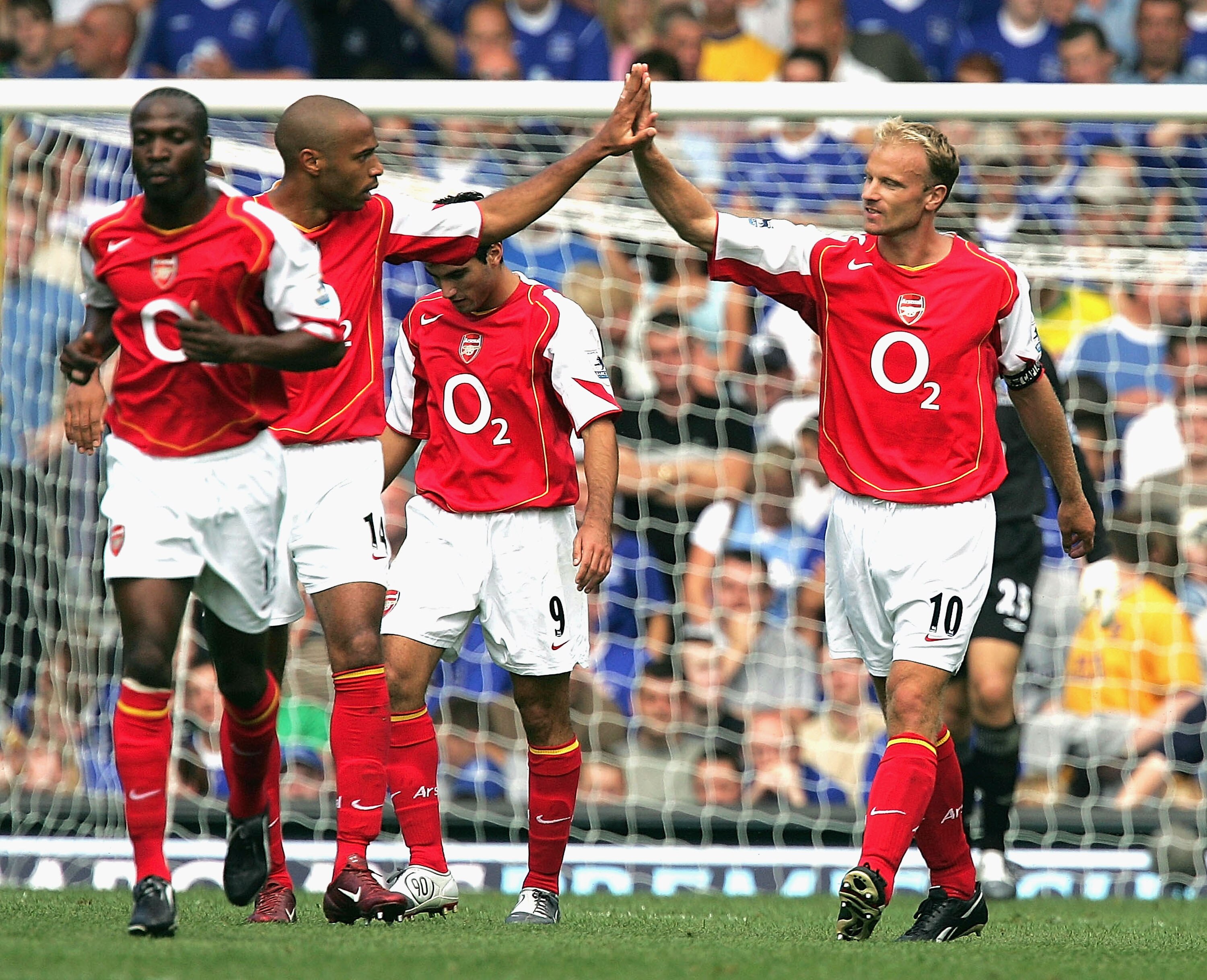 EVERTON, ENGLAND - AUGUST 15:  Dennis Bergkamp of Arsenal (R) celebrates with Thierry Henry after scoring the first goal during the Barclays Premiership match between Everton and Arsenal at Goodison Park on August 15, 2004 in Everton, England. (Photo by A