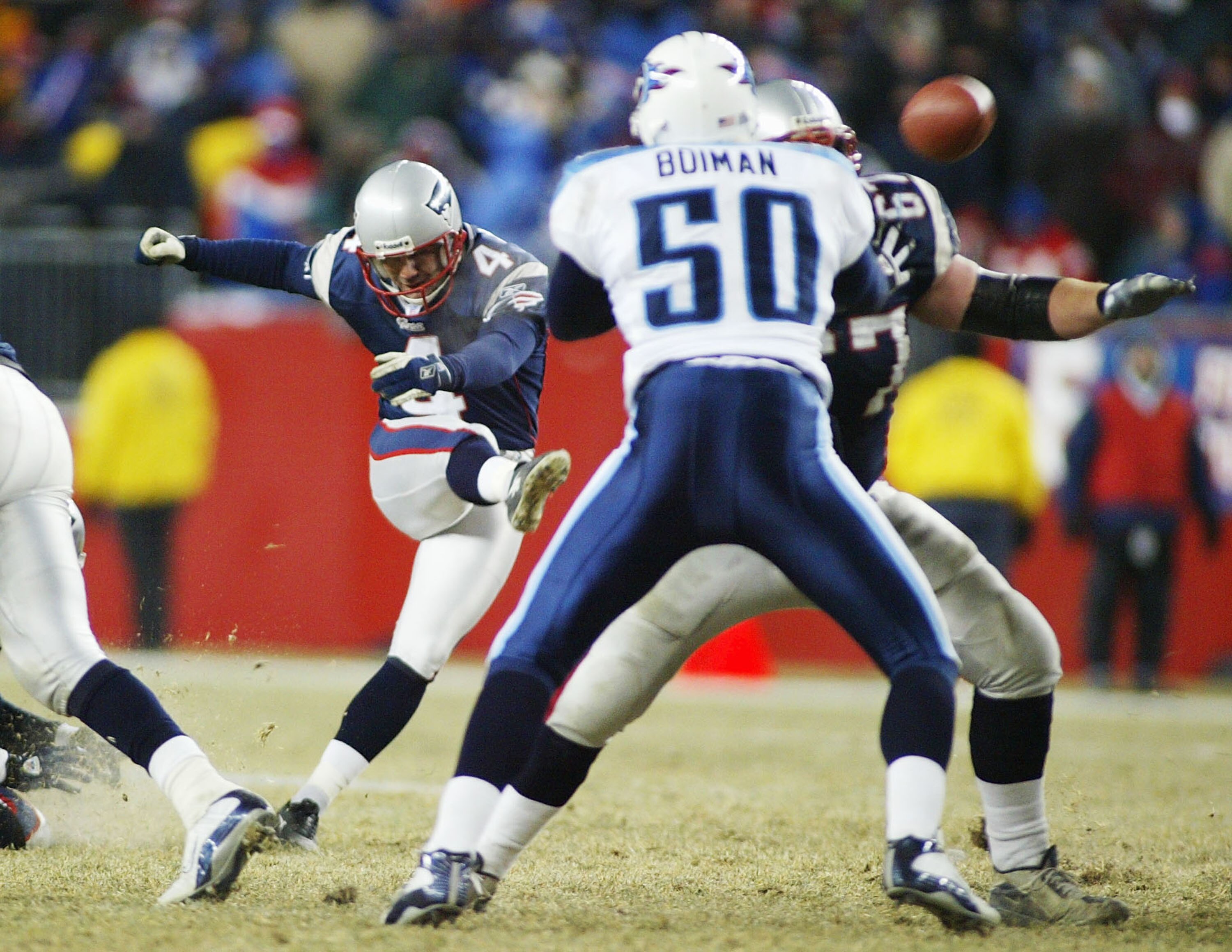 FOXBORO, MA - JANUARY 10:  Kicker Adam Vinatieri #4 of the New England Patriots kicks the game winning field goal in the forth quarter against the Tennessee Titans during the AFC divisional playoffs on January 10, 2004 at Gillette Stadium in Foxboro, Mass