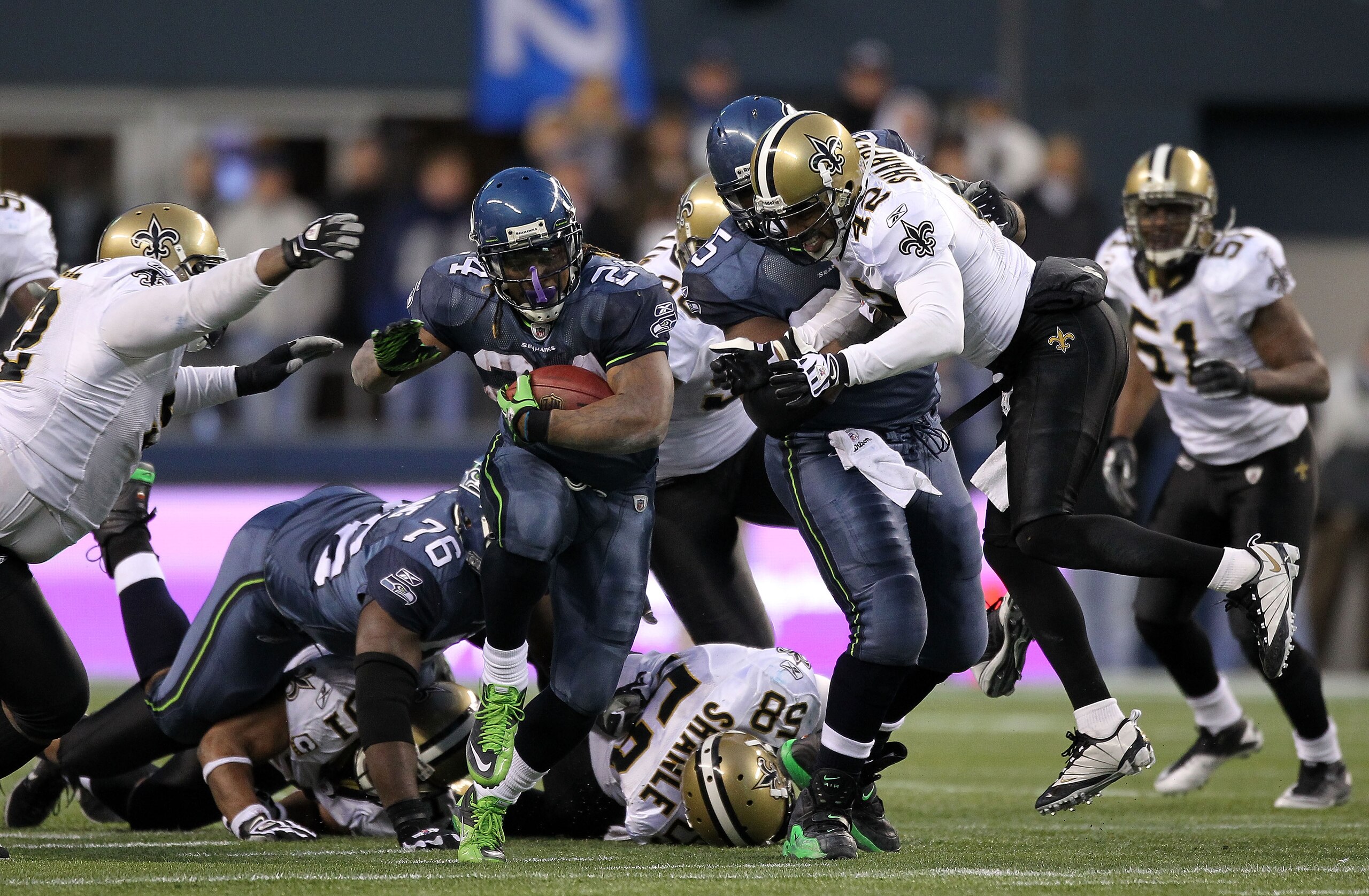 SEATTLE, WA - JANUARY 08:  Running back Marshawn Lynch #24 of the Seattle Seahawks runs for a 67-yard touchdown run in the fourth quarter against the New Orleans Saints during the 2011 NFC wild-card playoff game at Qwest Field on January 8, 2011 in Seattl