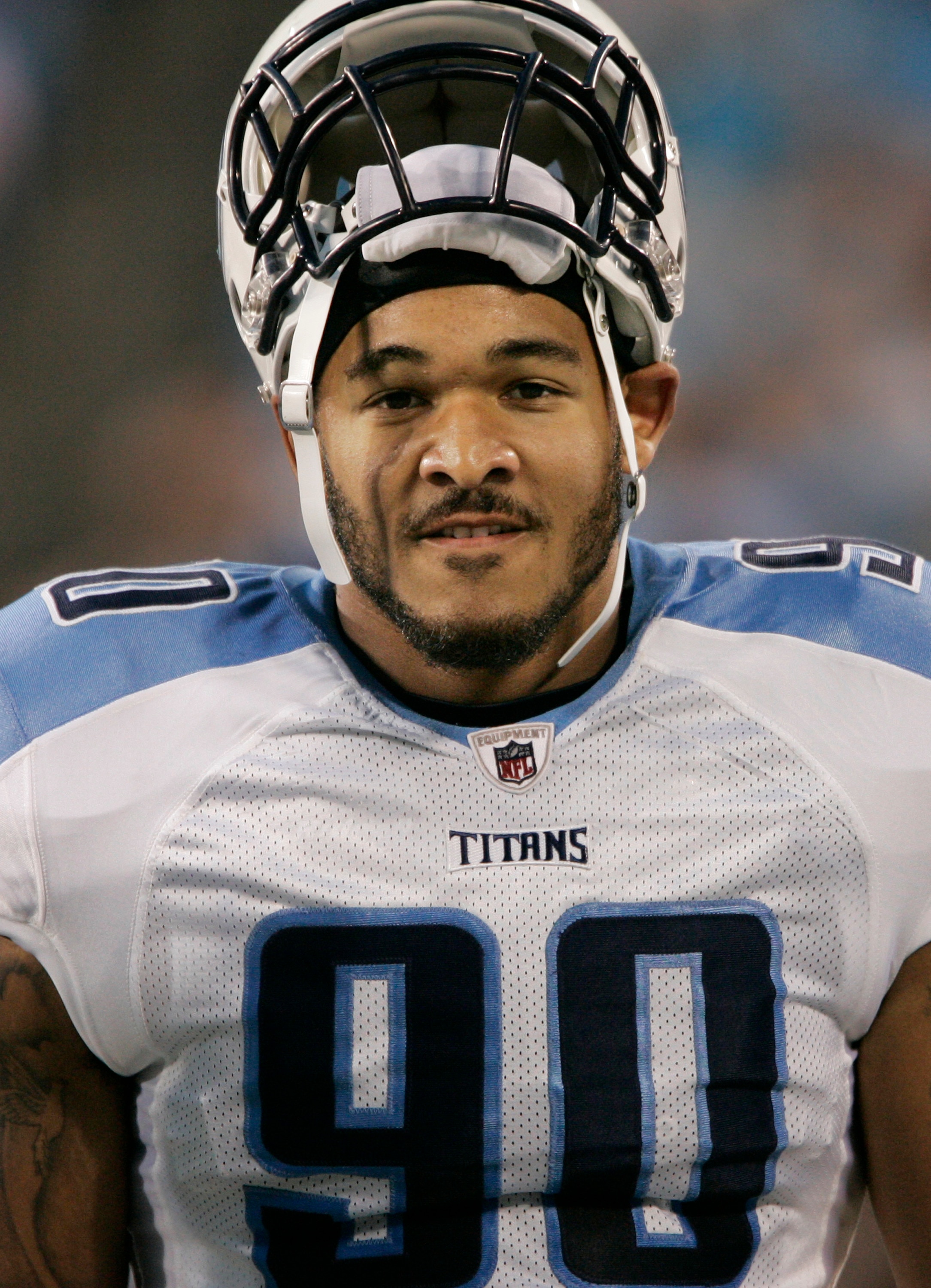 CHARLOTTE, NC - AUGUST 28:  Defensive end Derrick Morgan #90 of the Tennessee Titans rests his helmet on top of his head as he walks along the sidelines before the start of their preseason game against the Carolina Panther at Bank of America Stadium on Au