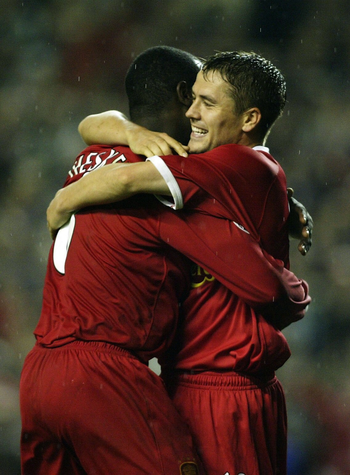 LIVERPOOL - OCTOBER 2:  Emile Heskey of Liverpool celebrates with Michael Owen after scoring the fifth goal during the Liverpool v Spartak Moscow UEFA Champions League phase one, Group B match at Anfield on October 2, 2002 in Liverpool, England. (Photo by