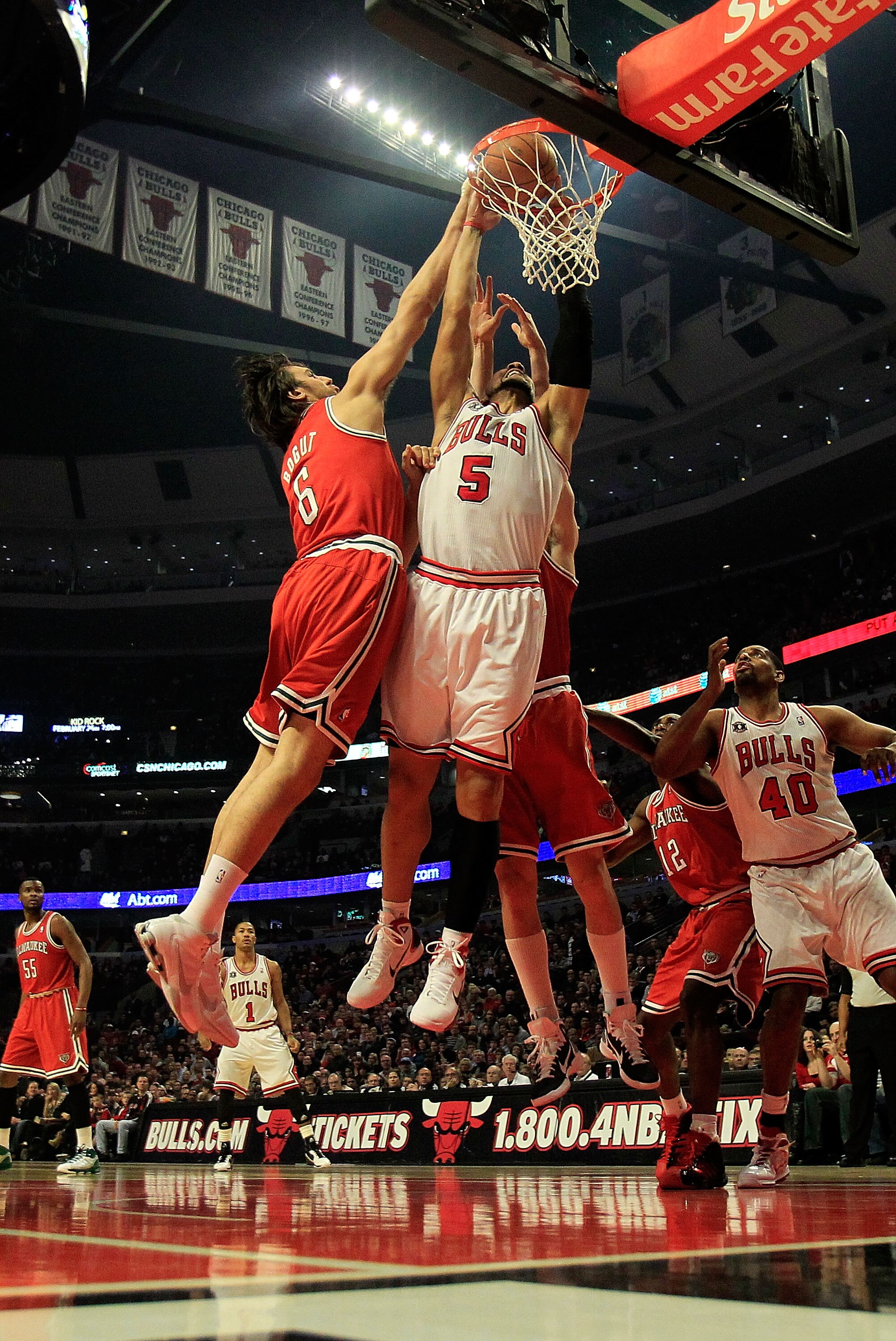CHICAGO, IL - DECEMBER 28: Carlos Boozer #5 of the Chicago Bulls dunks the ball between Andrew Bogut #6 and Ersan Ilyasova #7 of the Milwaukee Bucks at the United Center on December 28, 2010 in Chicago, Illinois. NOTE TO USER: User expressly acknowledges