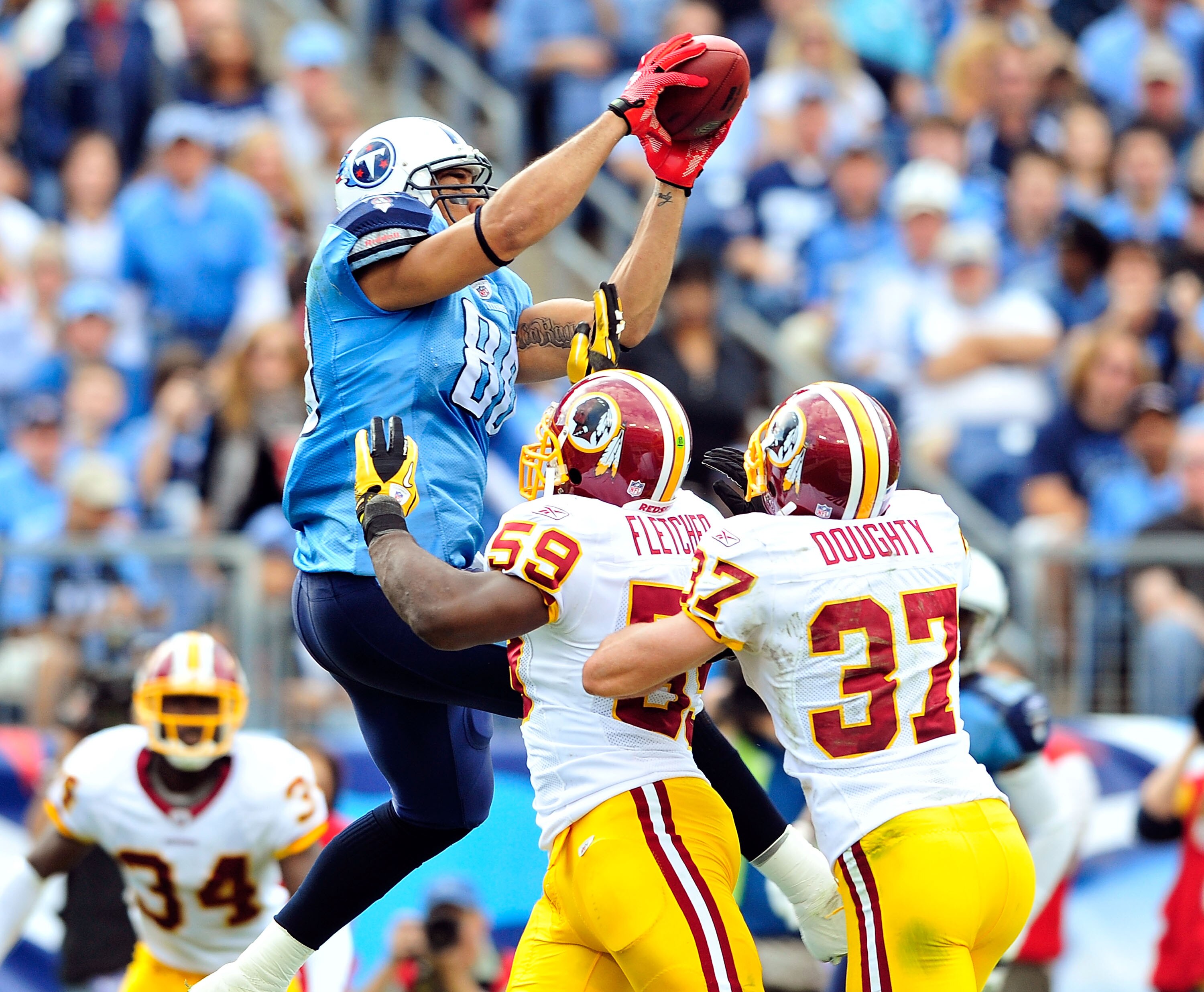 NASHVILLE, TN - NOVEMBER 21:  London Fletcher #59 and Reed Doughty #37 of the Washington Redskins force Bo Scaife #80 of the Tennessee Titans out of the end zone to prevent a touchdown at LP Field on November 21, 2010 in Nashville, Tennessee. The Redskins
