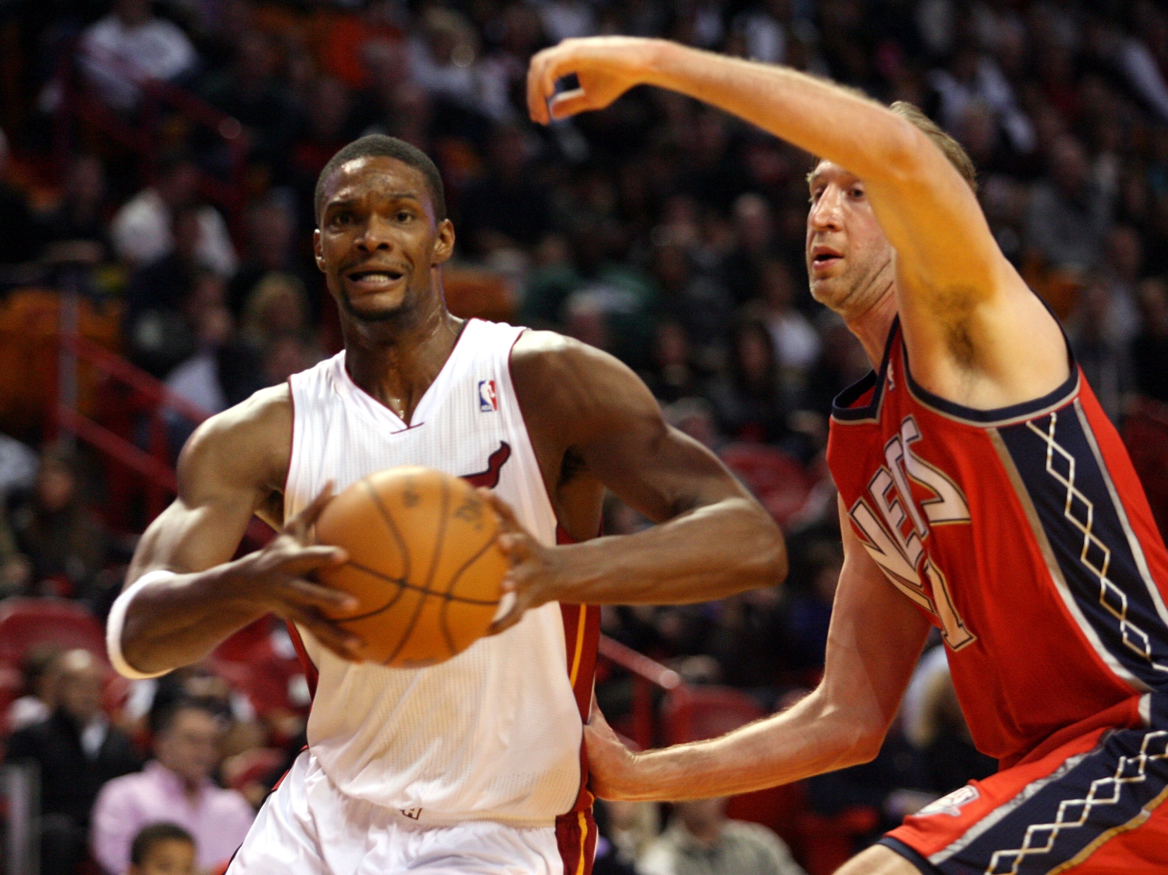 MIAMI - NOVEMBER 06: Forward Chris Bosh #1 of the Miami Heat drives against center Troy Murphy #7 of the New Jersey Nets at American Airlines Arena on November 6, 2010 in Miami, Florida. NOTE TO USER: User expressly acknowledges and agrees that, by down MIAMI - NOVEMBER 06: Forward Chris Bosh #1 of the Miami Heat drives against center Troy Murphy #7 of the New Jersey Nets at American Airlines Arena on November 6, 2010 in Miami, Florida. NOTE TO USER: User expressly acknowledges and agrees that, by down