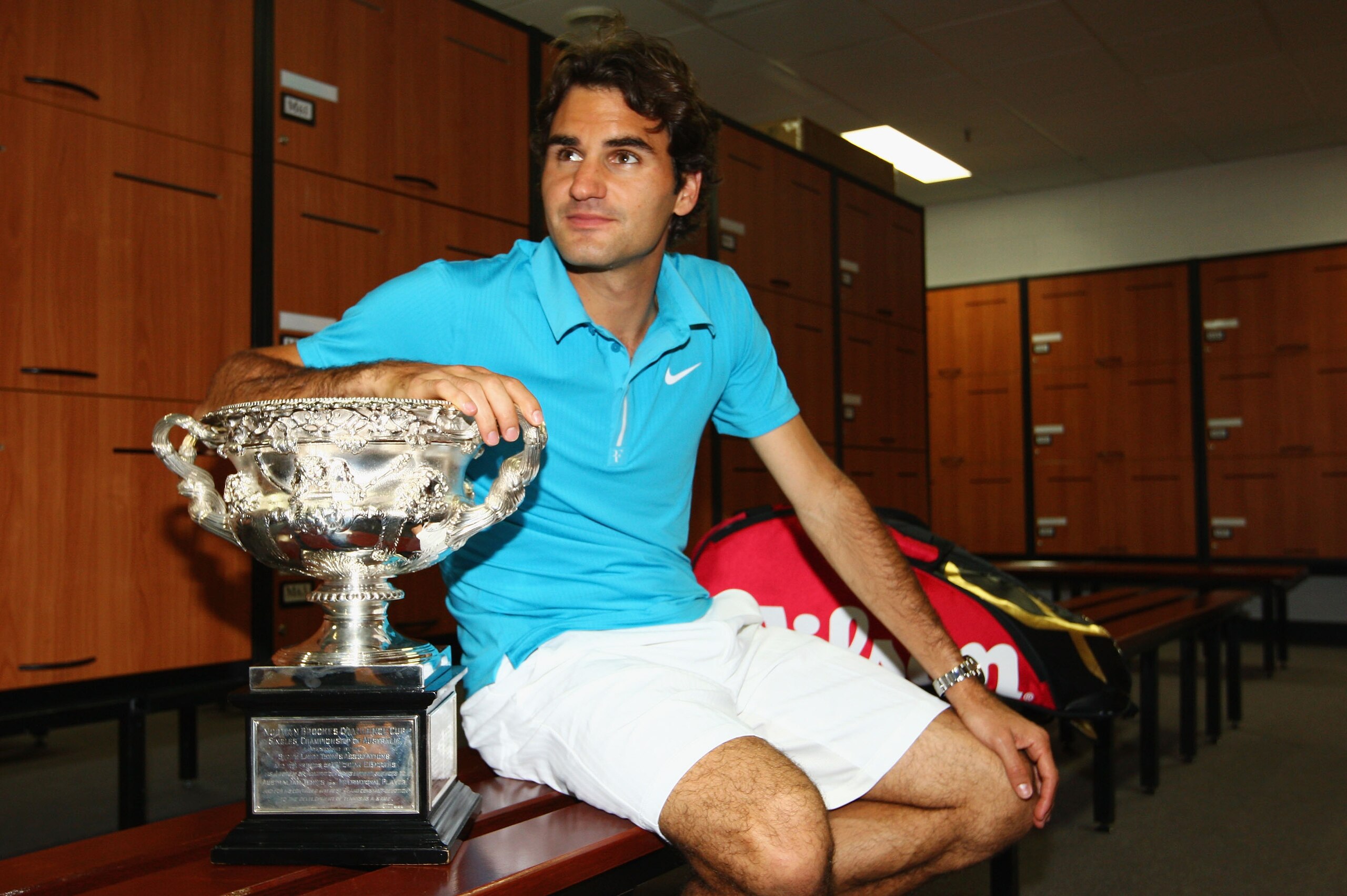 MELBOURNE, AUSTRALIA - JANUARY 31:  Roger Federer of Switzerland poses with the Norman Brookes Challenge Cup in the players locker room after winning the men's final match against Andy Murray of Great Britain during day fourteen of the 2010 Australian Ope