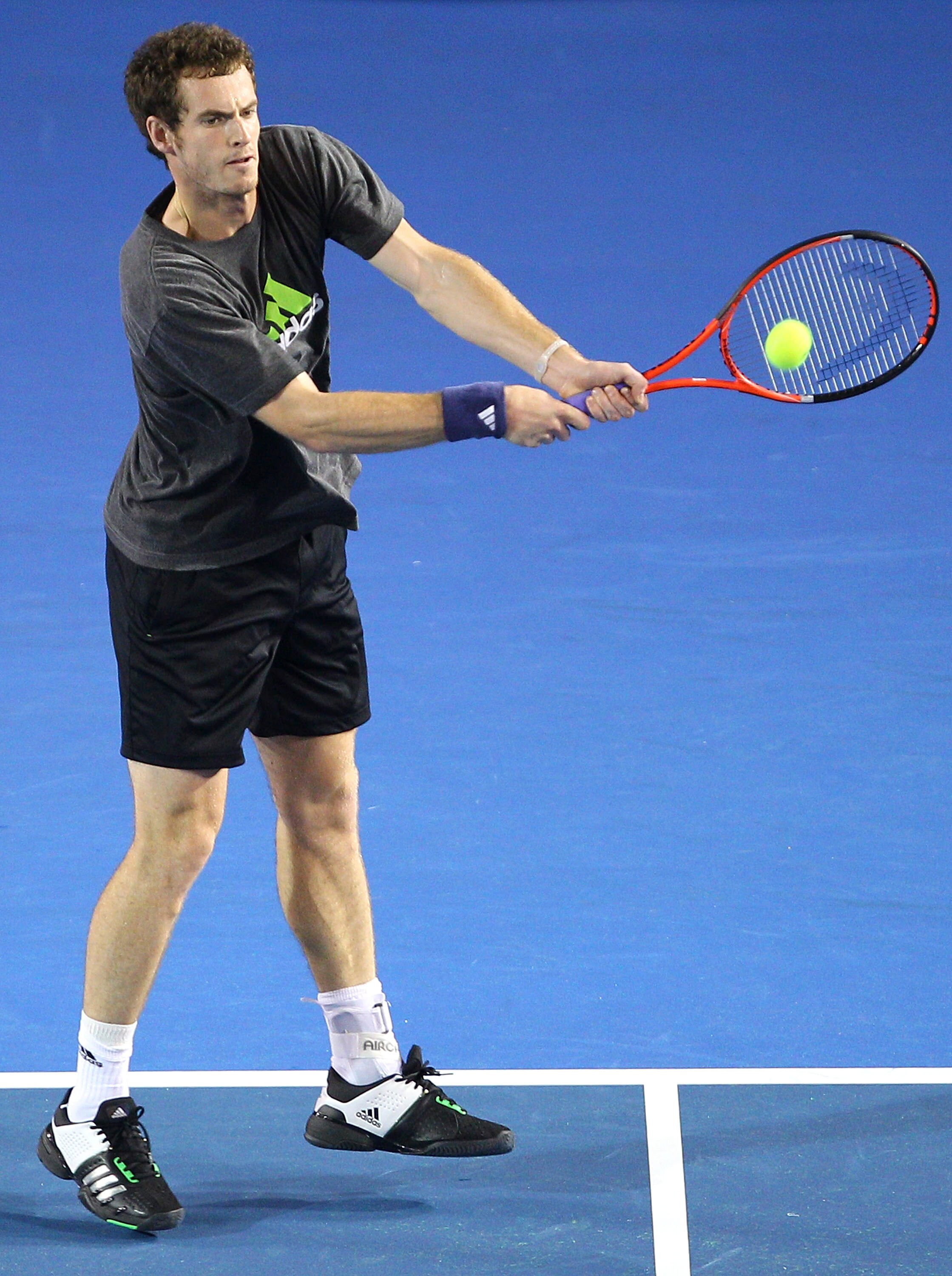 MELBOURNE, AUSTRALIA - JANUARY 14: Andy Murray of Great Britain hits a backhand during a practice session ahead of the 2011 Australian Open at Melbourne Park on January 14, 2011 in Melbourne, Australia. (Photo by Lucas Dawson/Getty Images)