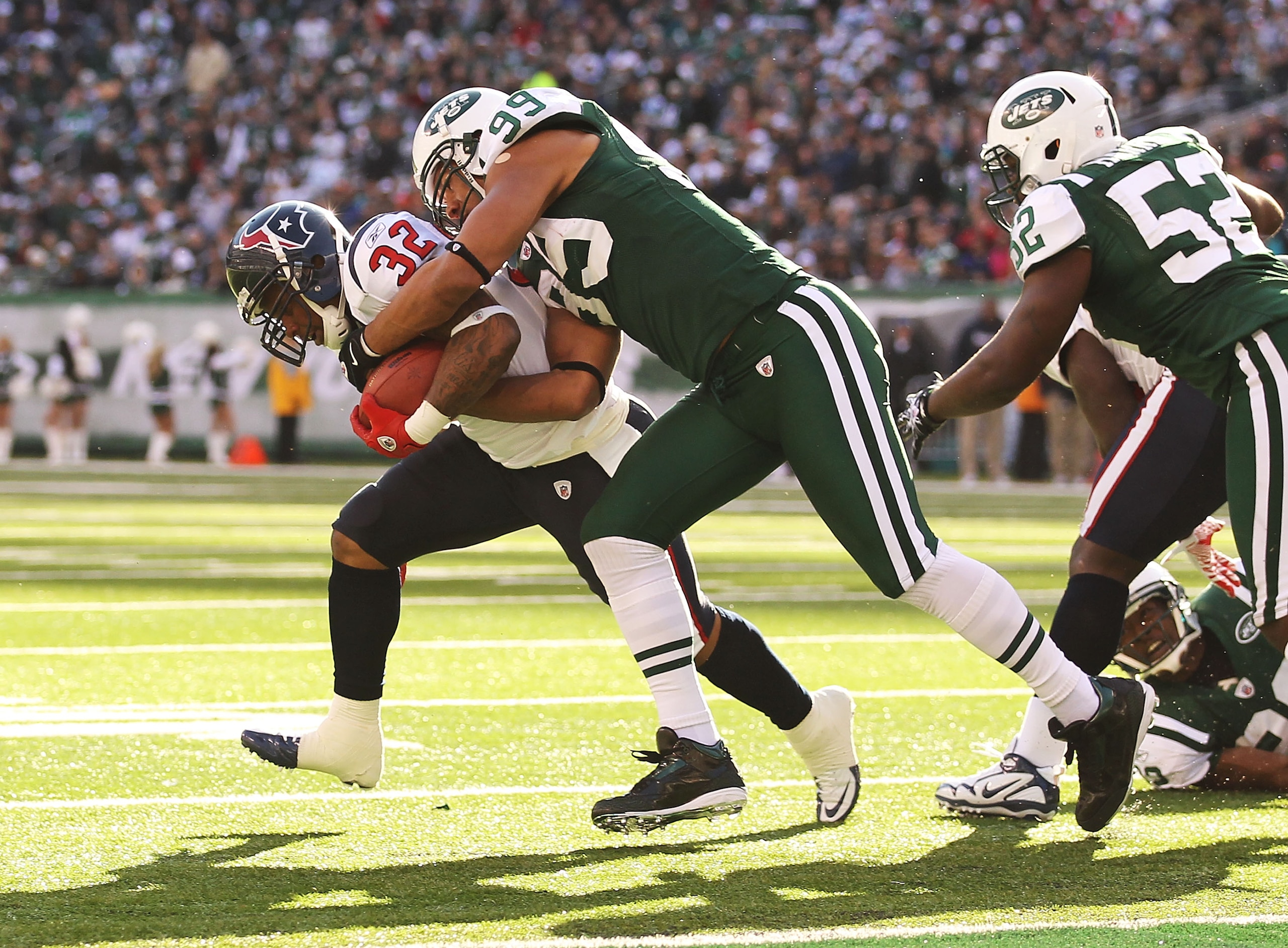 EAST RUTHERFORD, NJ - NOVEMBER 21:  Jason Taylor #99 of the New York Jets tackles Derrick ward #32 of the Houston Texans during their  game on November 21, 2010 at the New Meadowlands Stadium in East Rutherford, New Jersey.  (Photo by Al Bello/Getty Image