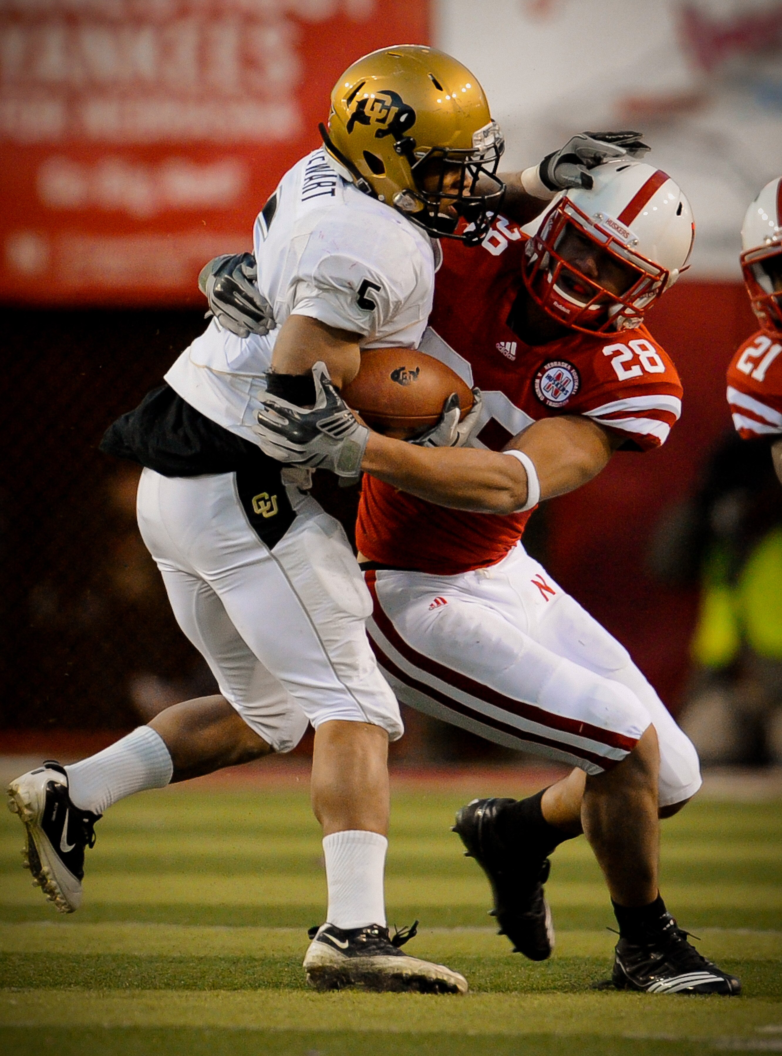 LINCOLN, NE - NOVEMBER 26: Eric Hagg #28 of the Nebraska Cornhuskers brings down Rodney Stewart #5 of the Colorado Buffaloes during the second half of their game at Memorial Stadium on November 26, 2010 in Lincoln, Nebraska. Nebraska defeated Colorado 45-