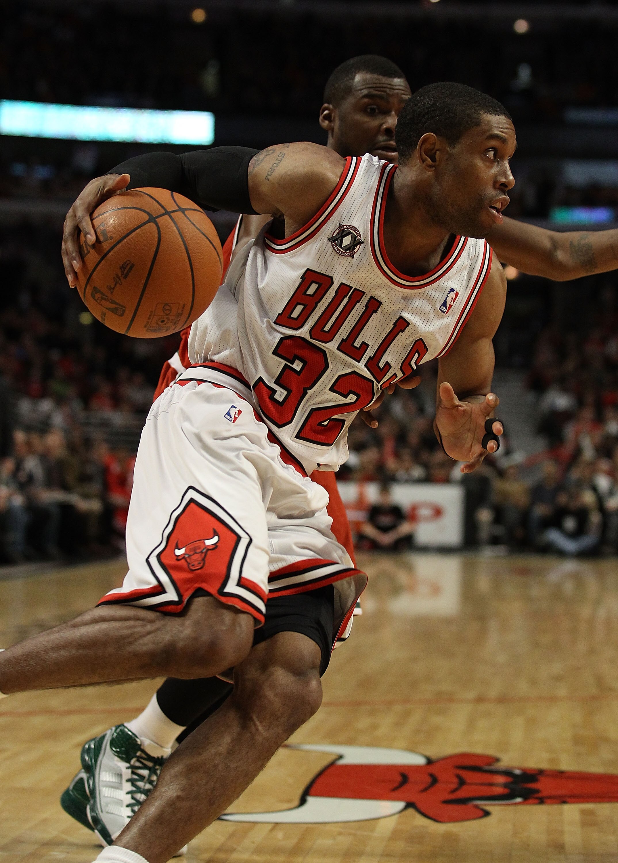 CHICAGO, IL - DECEMBER 28: C.J. Watson #32 of the Chicago Bulls drives against Keyon Dooling #55 of the Milwaukee Bucks at the United Center on December 28, 2010 in Chicago, Illinois. The Bulls defeated the Bucks 90-77. NOTE TO USER: User expressly acknow