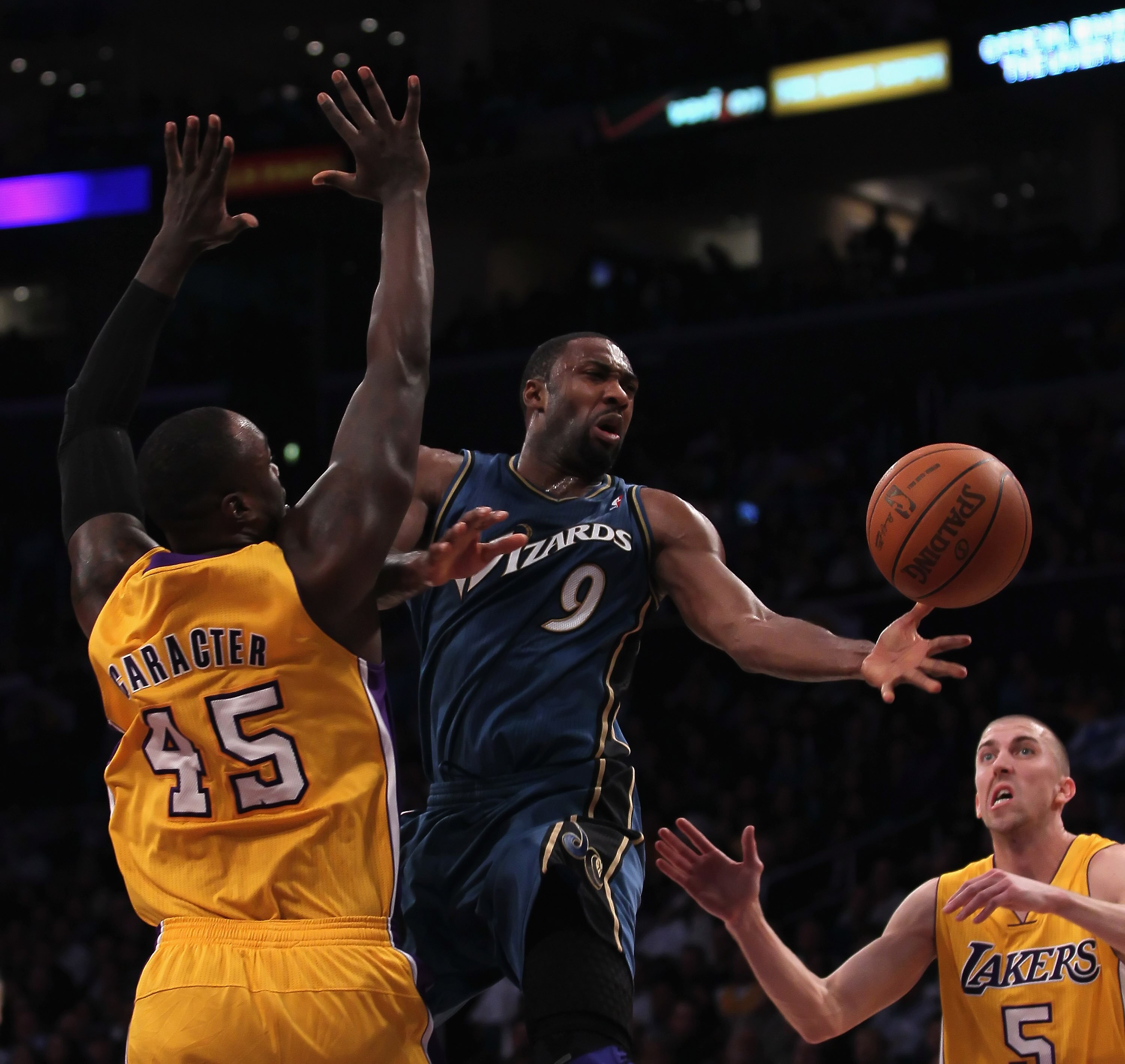 LOS ANGELES, CA - DECEMBER 07:  Gilbert Arenas #9 of the Washington Wizards passes the ball between Derrick Caracter #45 and Steve Blake #5 of the Los Angeles Lakers in the second half at Staples Center on December 7, 2010 in Los Angeles, California. The