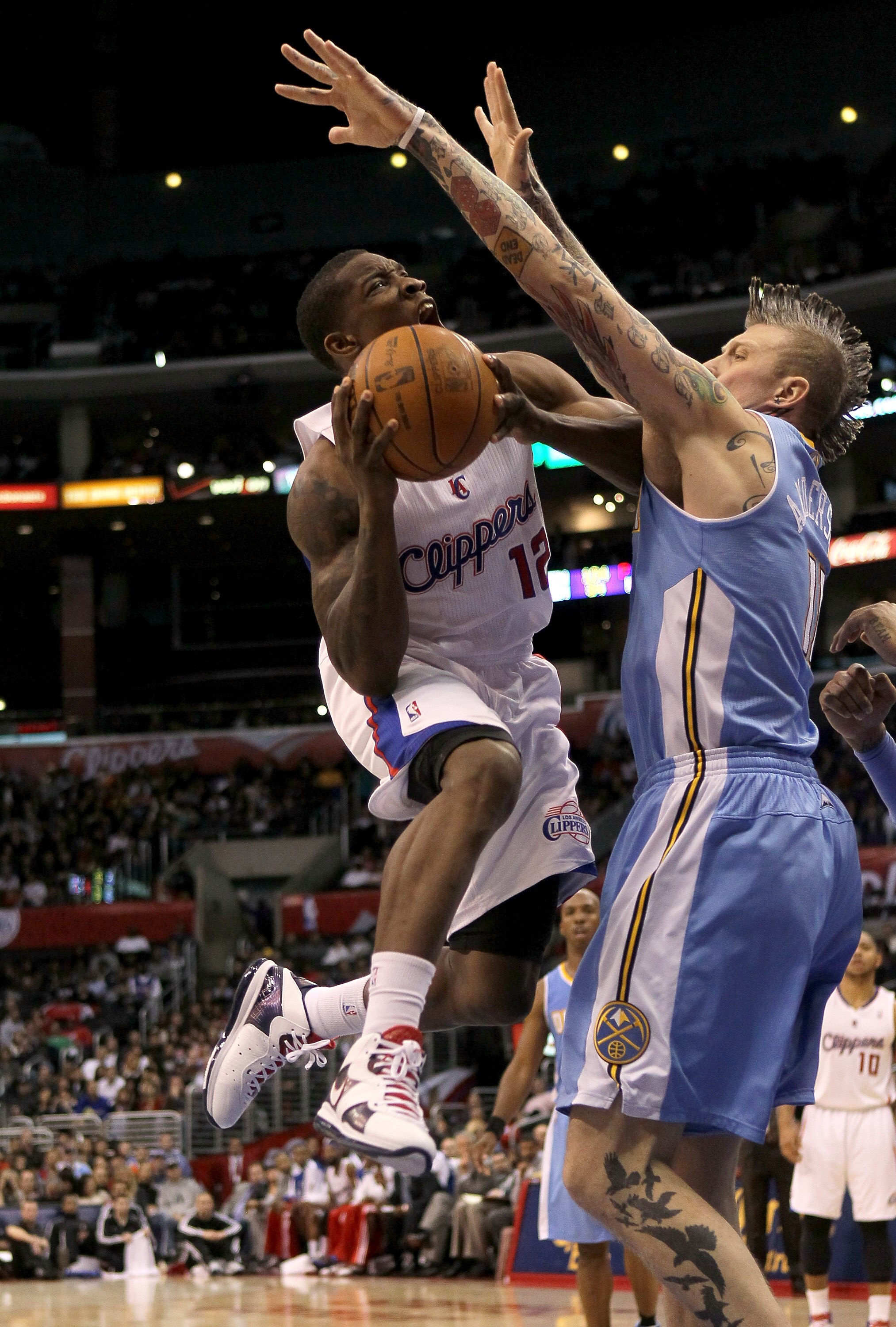 LOS ANGELES, CA - JANUARY 05:  Eric Bledsoe #12 of the Los Angeles Clippers goes up for a shot against Chris Andersen #11 of the Denver Nuggets at Staples Center on January 5, 2011  in Los Angeles, California. The Clippers won 106-93.  NOTE TO USER: User