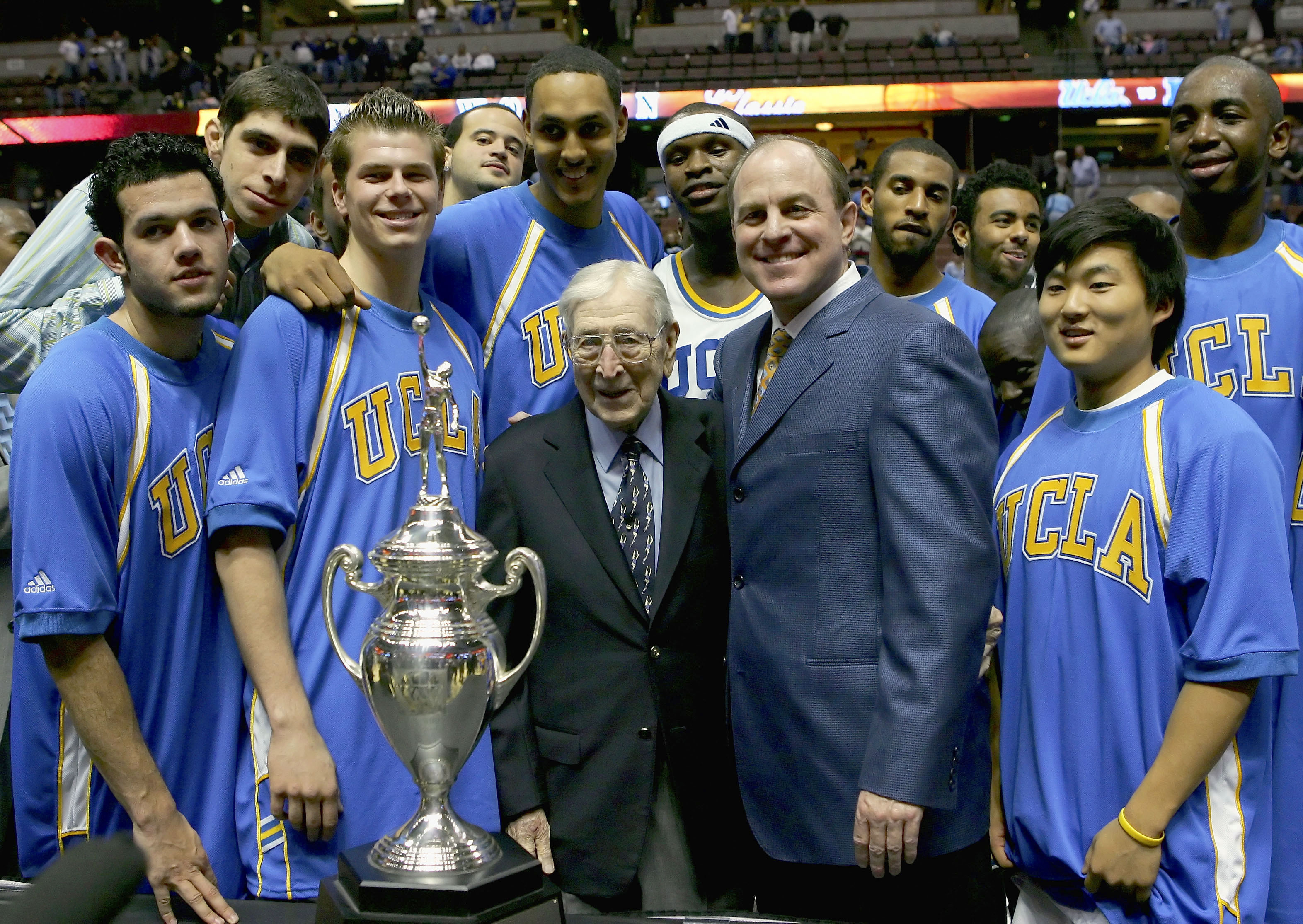 ANAHEIM, CA - DECEMBER 10:  The UCLA Bruins stand with John Wooden after defeating the Nevada Wolf Pack 67-56 during the 12th Annual John R. Wooden Classic on December 10, 2005 at Arrowhead Pond of Anaheim in Anaheim, California.  (Photo by Lisa Blumenfel
