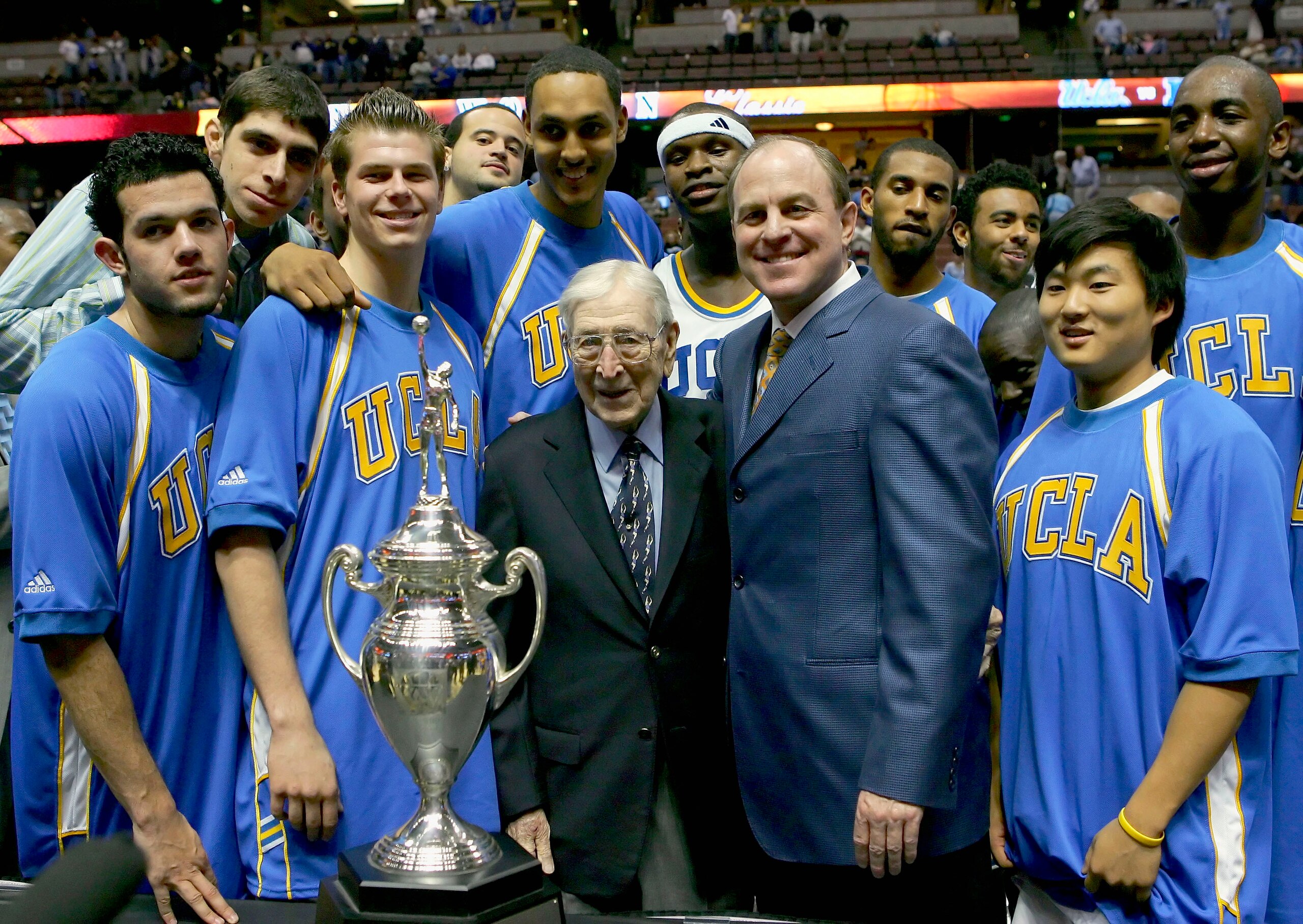 ANAHEIM, CA - DECEMBER 10:  The UCLA Bruins stand with John Wooden after defeating the Nevada Wolf Pack 67-56 during the 12th Annual John R. Wooden Classic on December 10, 2005 at Arrowhead Pond of Anaheim in Anaheim, California.  (Photo by Lisa Blumenfel