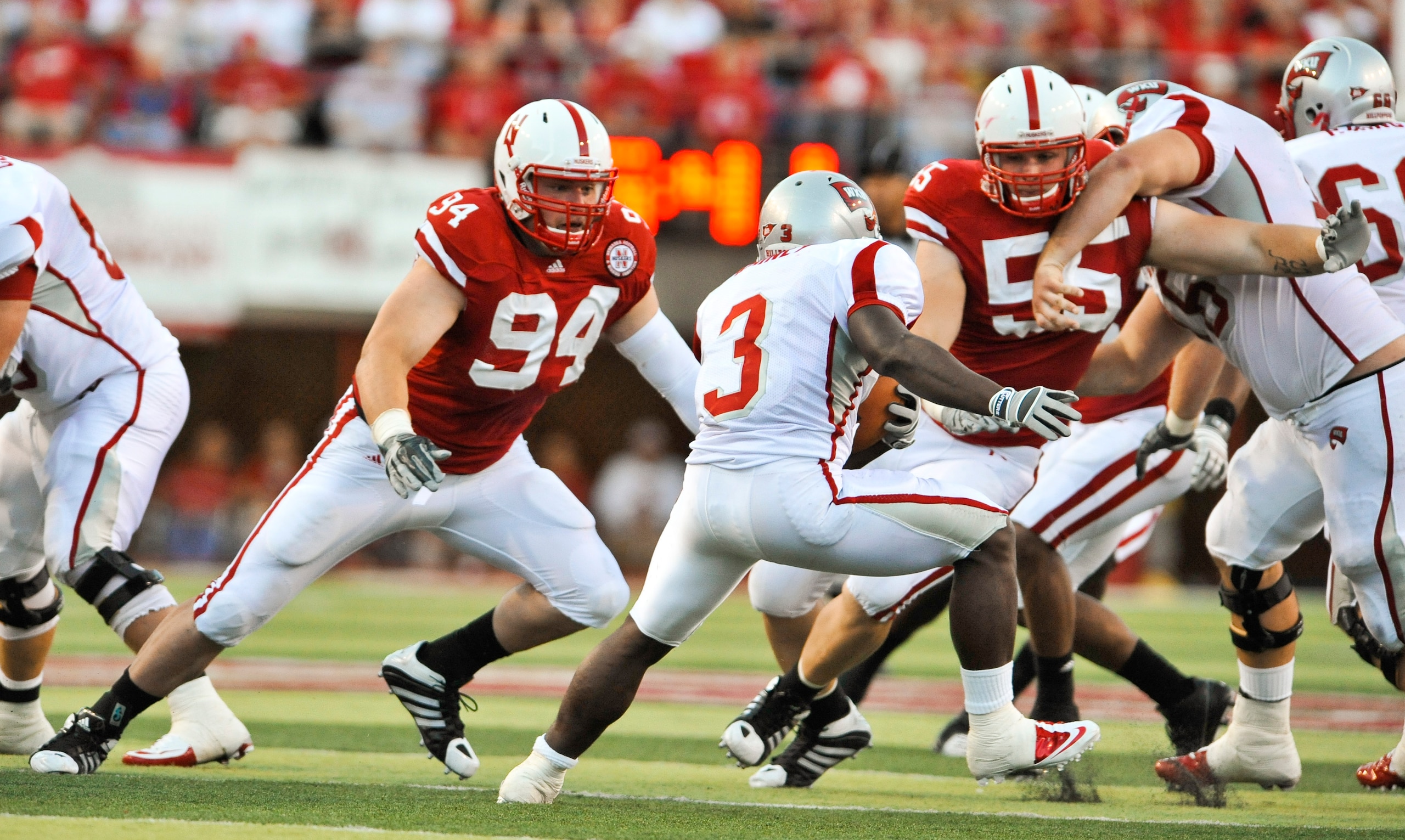 LINCOLN, NE - SEPTEMBER 04:  Jared Crick #94 and Baker Steinkuhler #55 of the Nebraska Cornhuskers take a bead on Bobby Rainey of the Western Kentucky Hilltoppers during first half action of their game at Memorial Stadium on September 4, 2010 in Lincoln,