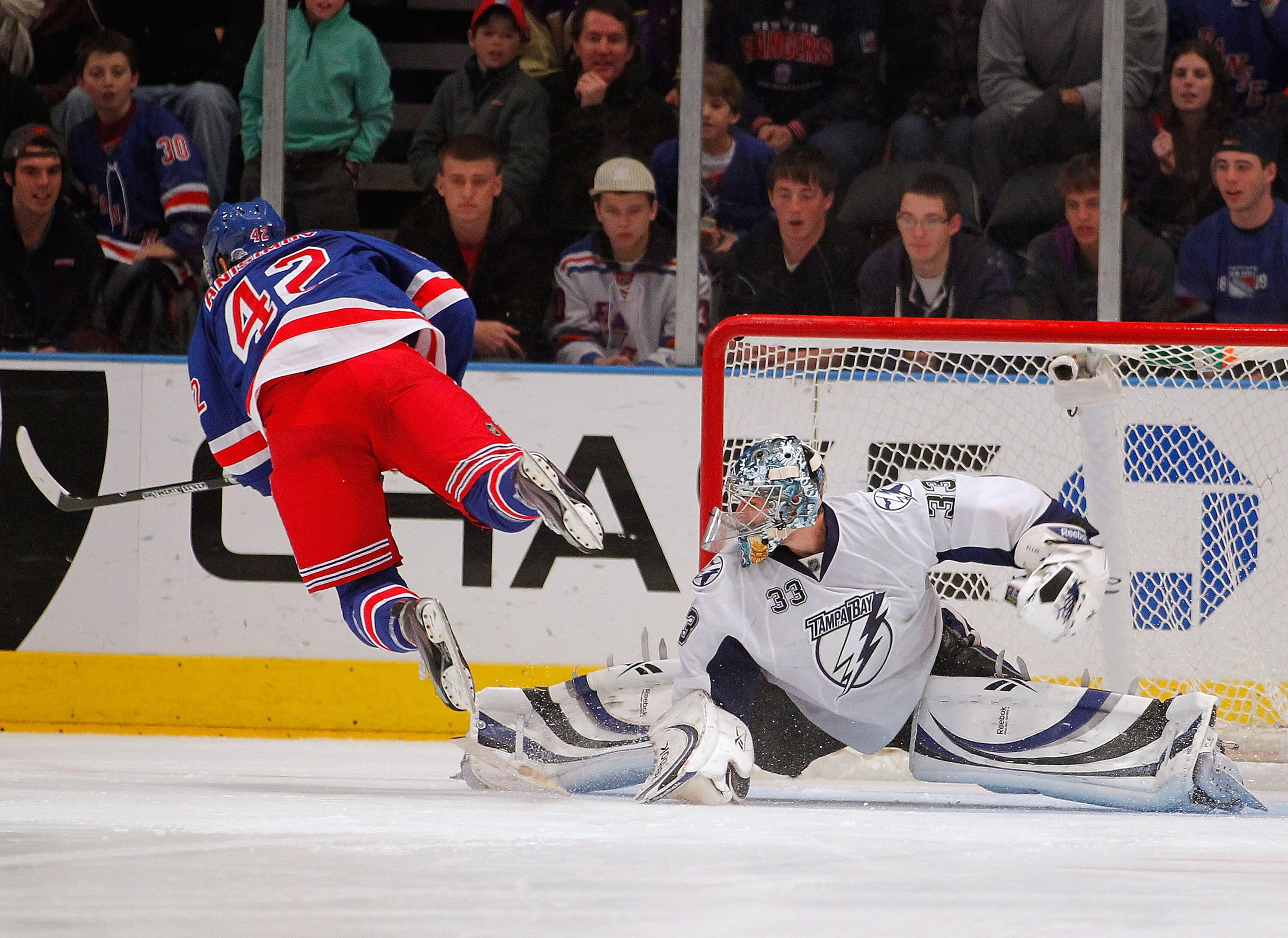 NEW YORK, NY - DECEMBER 23:  Artem Anisimov #42 of the New York Rangers is stopped and tripped by Goalie Dan Ellis #33 of the Tampa Bay Lightning during the shootout of an NHL hockey game at Madison Square Garden on December 23, 2010 in New York City.  (P