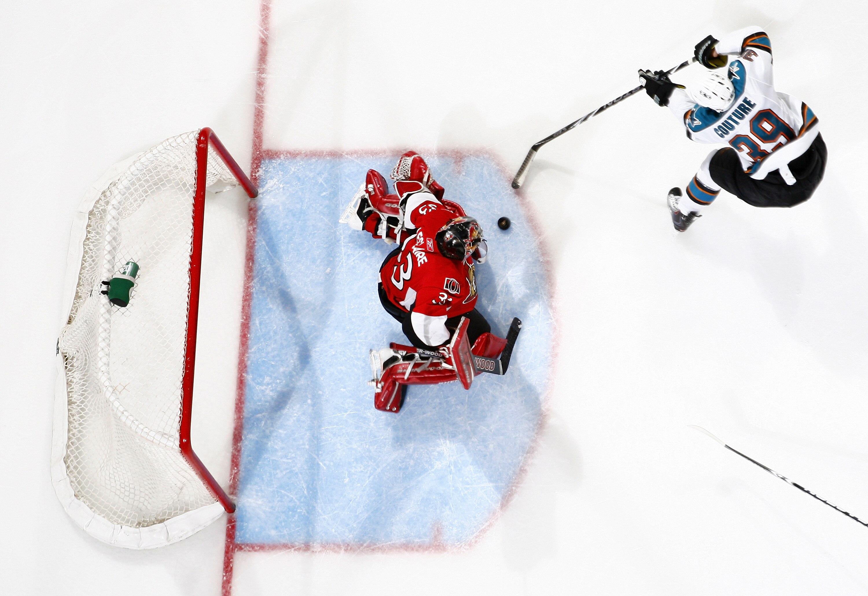 OTTAWA, ON - DECEMBER 02:  Logan Couture #39 of the San Jose Sharks slides the puck five-hole on Pascal Leclaire #33 of the Ottawa Senators for a goal in a game at Scotiabank Place on December 2, 2010 in Ottawa, Ontario, Canada.  (Photo by Phillip MacCall