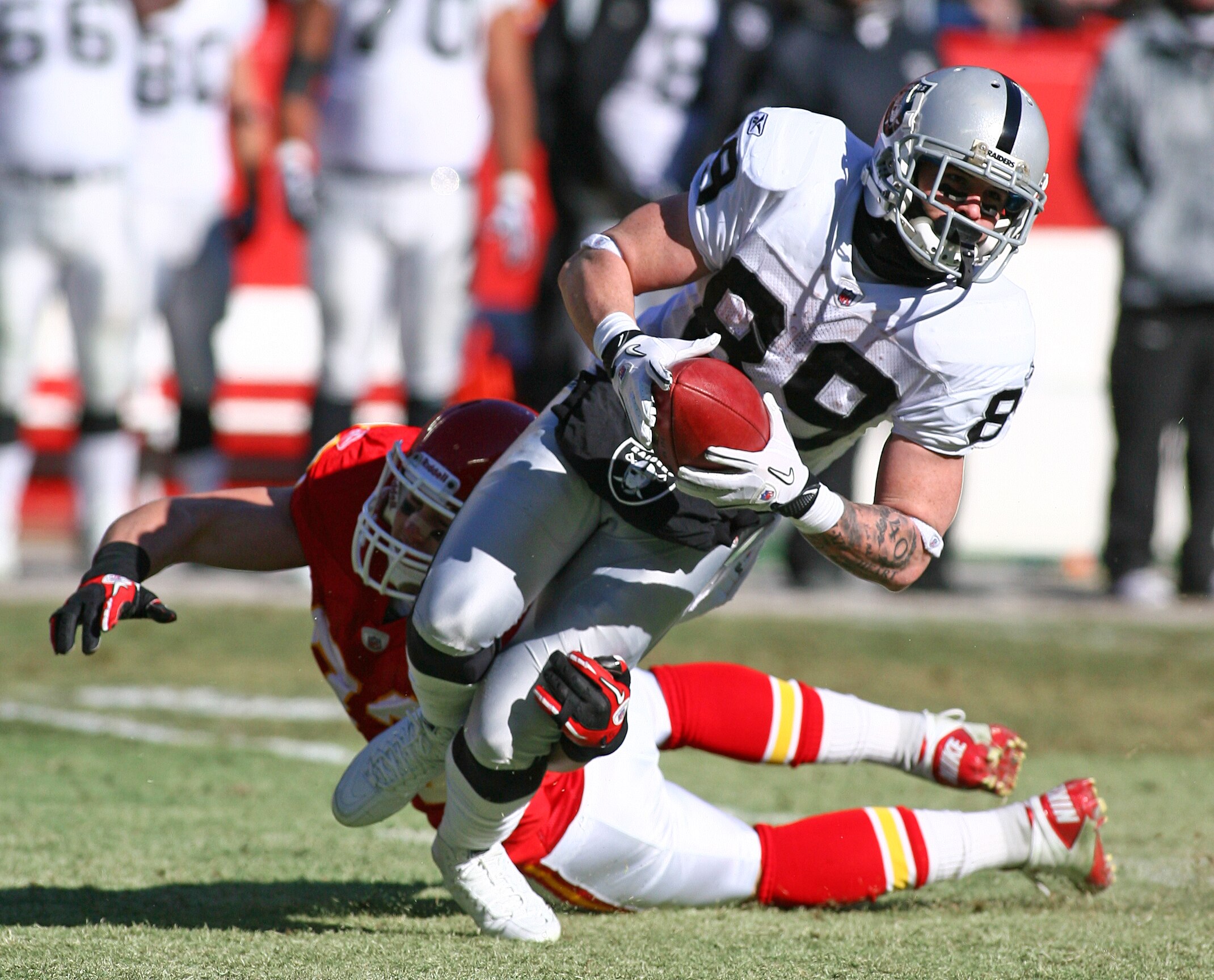 KANSAS CITY, MO - JANUARY 02:  Wide receiver Nick Miller #89 of the Oakland Raiders is tackled by linebacker Cory Greenwood #93 of the Kansas City Chiefs in a game at Arrowhead Stadium on January 2, 2011 in Kansas City, Missouri.  (Photo by Tim Umphrey/Ge