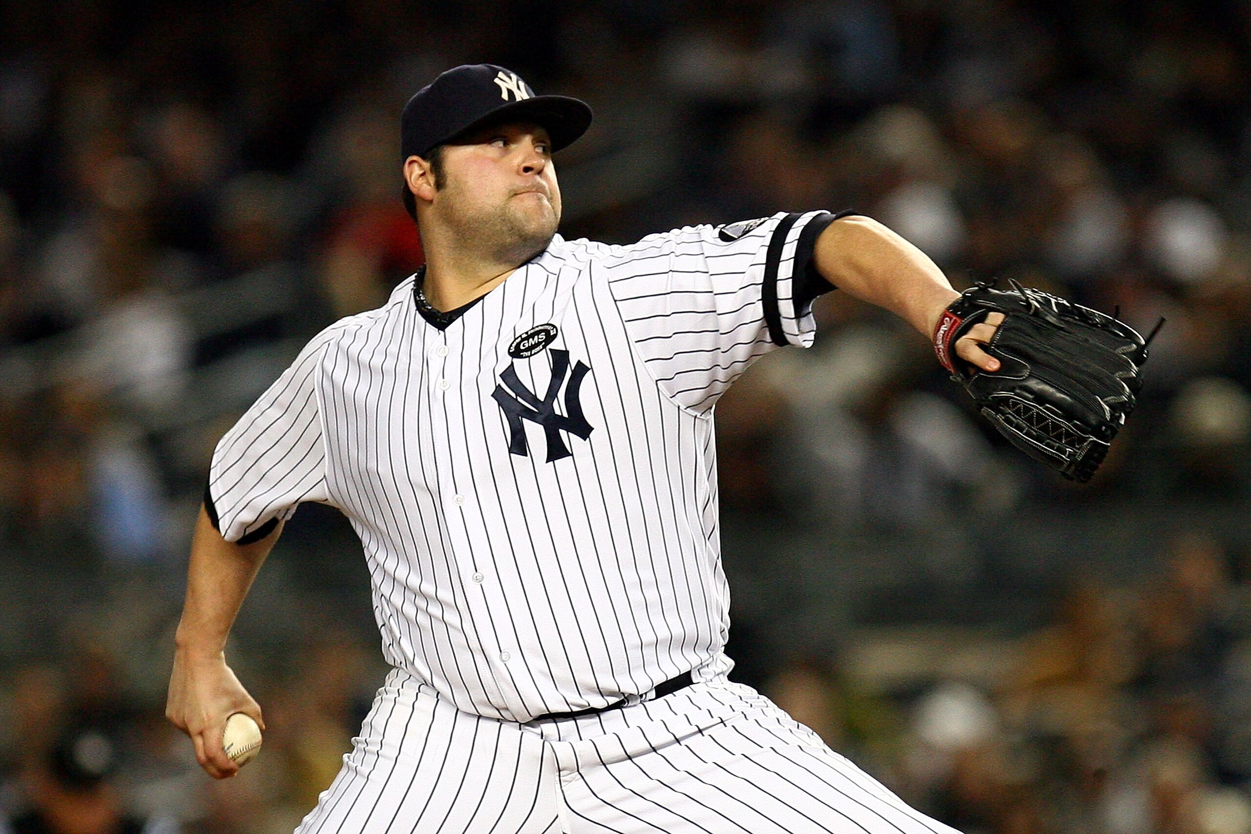 NEW YORK - OCTOBER 19: Joba Chamberlain #62 of the New York Yankees pitches against the Texas Rangers in Game Four of the ALCS during the 2010 MLB Playoffs at Yankee Stadium on October 19, 2010 in the Bronx borough of New York City. (Photo by Andrew Bur NEW YORK - OCTOBER 19: Joba Chamberlain #62 of the New York Yankees pitches against the Texas Rangers in Game Four of the ALCS during the 2010 MLB Playoffs at Yankee Stadium on October 19, 2010 in the Bronx borough of New York City. (Photo by Andrew Bur