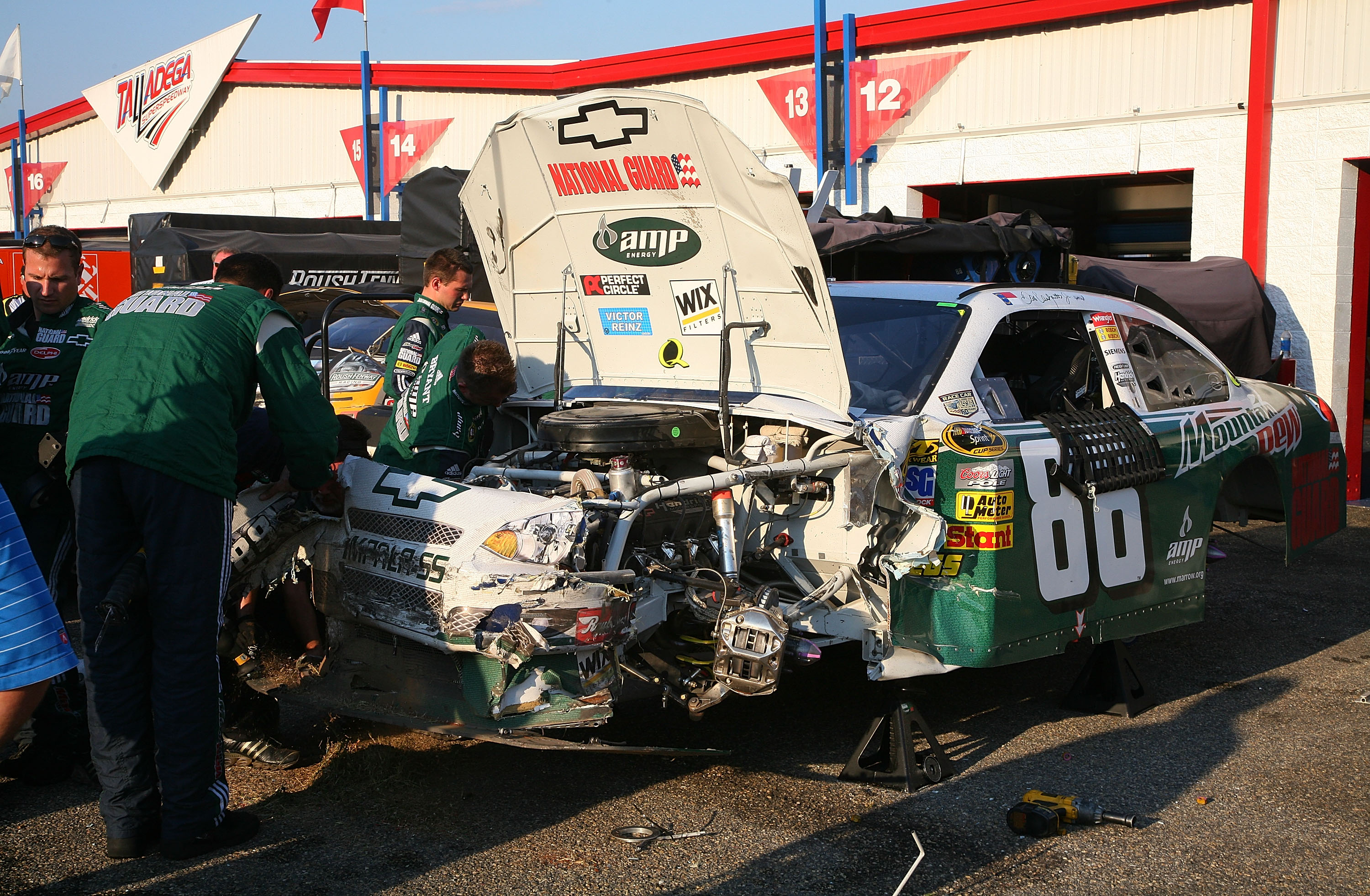 TALLADEGA, AL - OCTOBER 05:  Crew of the #88 AMP Energy Ride With Dale Jr./National Guard Chevrolet driven by Dale Earnhardt Jr. attempt repairs after crashing during the NASCAR Sprint Cup Series Amp Energy 500 at Talladega Superspeedway on October 5, 200
