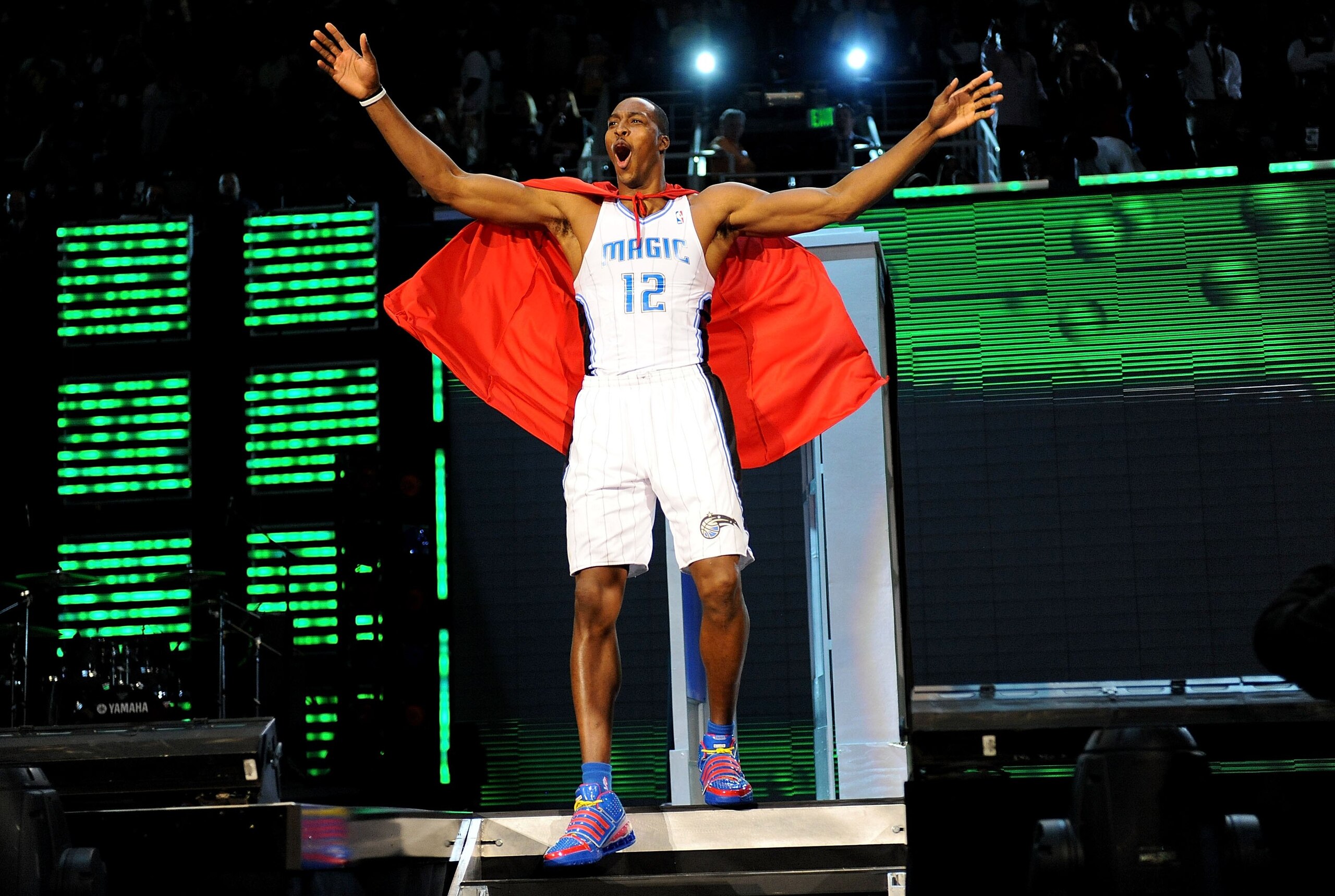 PHOENIX - FEBRUARY 14: Dwight Howard of the Orlando Magic emerges from a phone booth wearing a Superman cape during the Sprite Slam Dunk Contest on All-Star Saturday Night, part of 2009 NBA All-Star Weekend at US Airways Center on February 14, 2009 in Ph PHOENIX - FEBRUARY 14: Dwight Howard of the Orlando Magic emerges from a phone booth wearing a Superman cape during the Sprite Slam Dunk Contest on All-Star Saturday Night, part of 2009 NBA All-Star Weekend at US Airways Center on February 14, 2009 in Ph