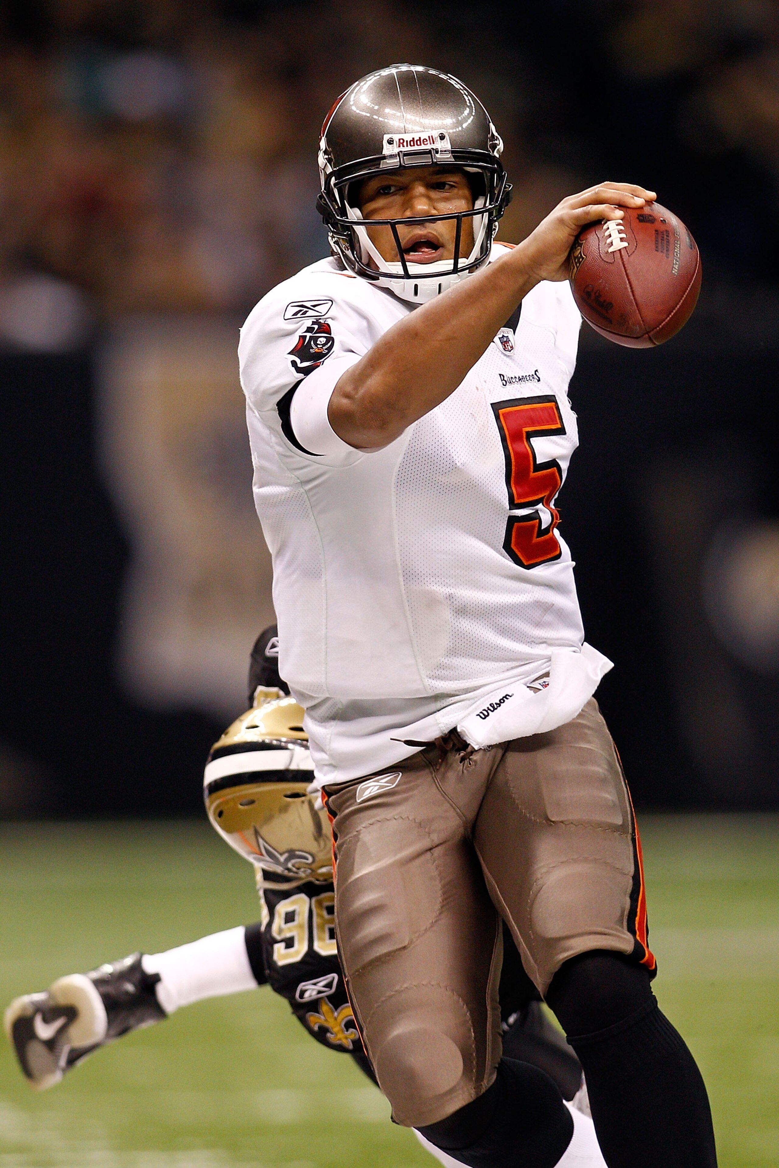 NEW ORLEANS, LA - JANUARY 02: Quarterback Josh Freeman #5 of the Tampa Bay Buccaneers is pushed out of bounds by Alex Brown #96 of the New Orleans Saints at the Louisiana Superdome on January 2, 2011 in New Orleans, Louisiana. The Buccaneers defeated th NEW ORLEANS, LA - JANUARY 02: Quarterback Josh Freeman #5 of the Tampa Bay Buccaneers is pushed out of bounds by Alex Brown #96 of the New Orleans Saints at the Louisiana Superdome on January 2, 2011 in New Orleans, Louisiana. The Buccaneers defeated th