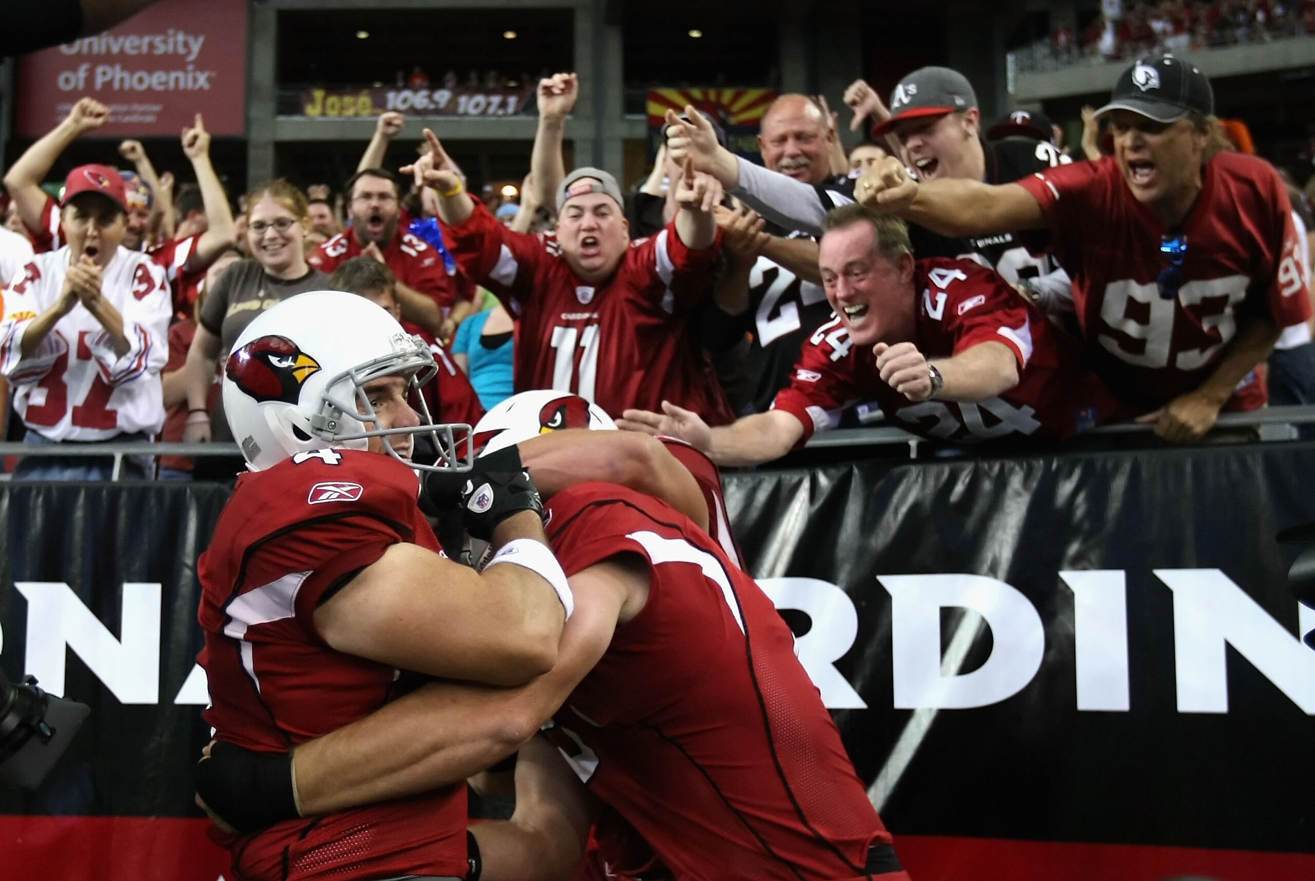 GLENDALE, AZ - DECEMBER 12: Kicker Jay Feely #4 of the Arizona Cardinals celebrates with teamamtes and fans after scoring on a 5 yard rushing touchdown against the Denver Broncos during the second quarter of the NFL game at the University of Phoenix Stad GLENDALE, AZ - DECEMBER 12: Kicker Jay Feely #4 of the Arizona Cardinals celebrates with teamamtes and fans after scoring on a 5 yard rushing touchdown against the Denver Broncos during the second quarter of the NFL game at the University of Phoenix Stad
