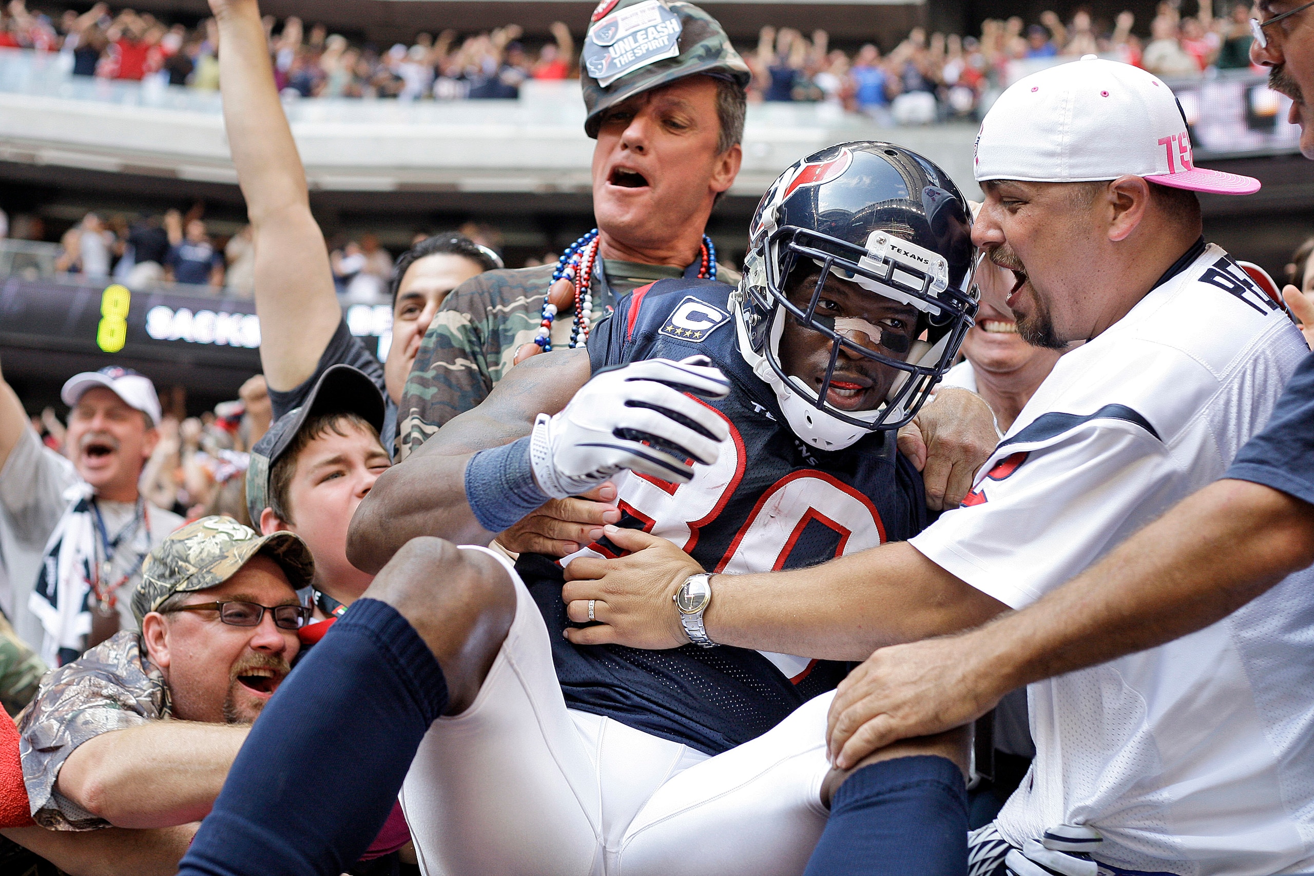 HOUSTON - OCTOBER 17: Andre Johnson #80 of the Houston Texans is mobbed by fans after he scored the go ahead touchdown in the fourth quarter against the Kansas City Chiefs at Reliant Stadium on October 17, 2010 in Houston, Texas. (Photo by Bob Levey/Get HOUSTON - OCTOBER 17: Andre Johnson #80 of the Houston Texans is mobbed by fans after he scored the go ahead touchdown in the fourth quarter against the Kansas City Chiefs at Reliant Stadium on October 17, 2010 in Houston, Texas. (Photo by Bob Levey/Get