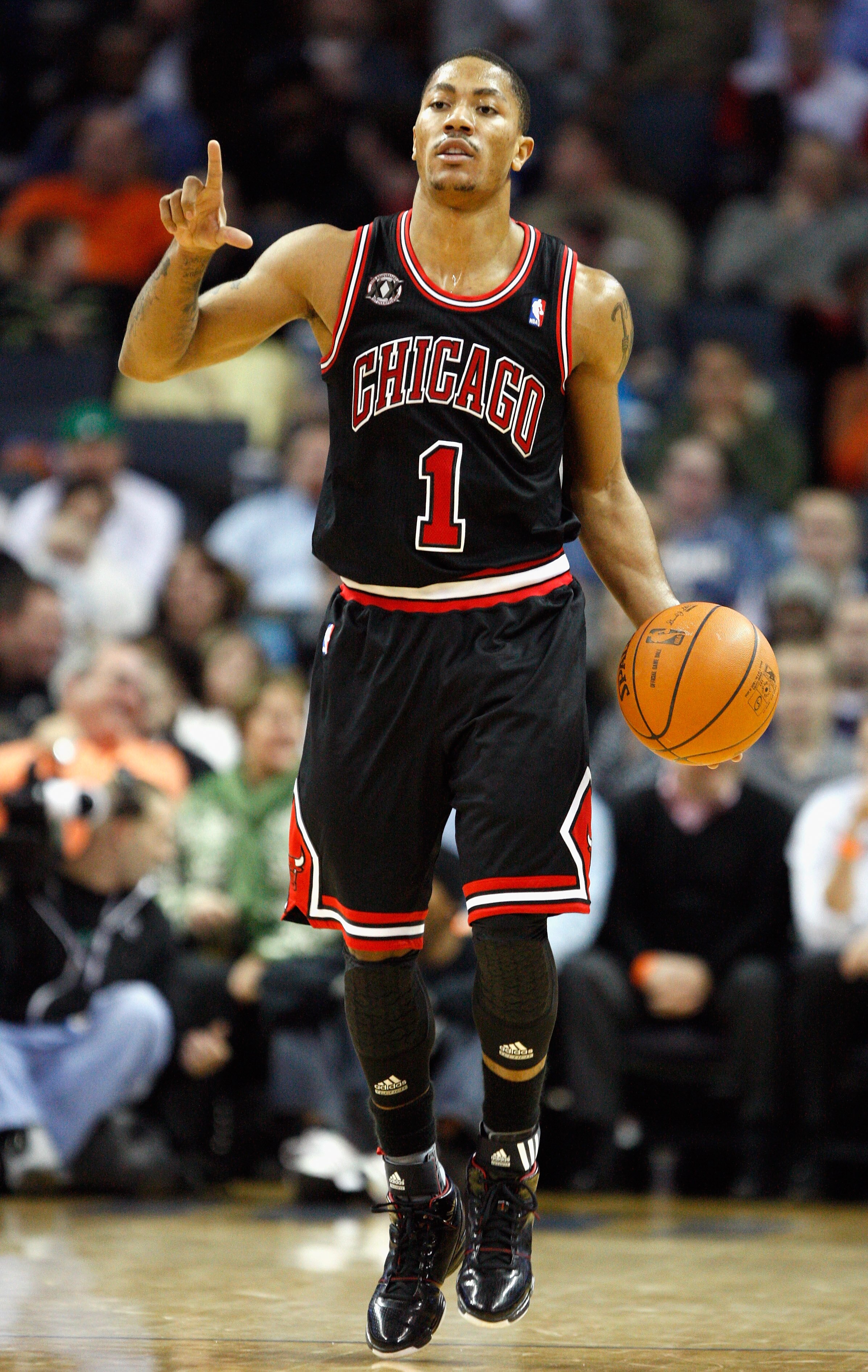 CHARLOTTE, NC - JANUARY 12:  Derrick Rose #1 of the Chicago Bulls calls a play against the Charlotte Bobcats during their game at Time Warner Cable Arena on January 12, 2011 in Charlotte, North Carolina. NOTE TO USER: User expressly acknowledges and agree